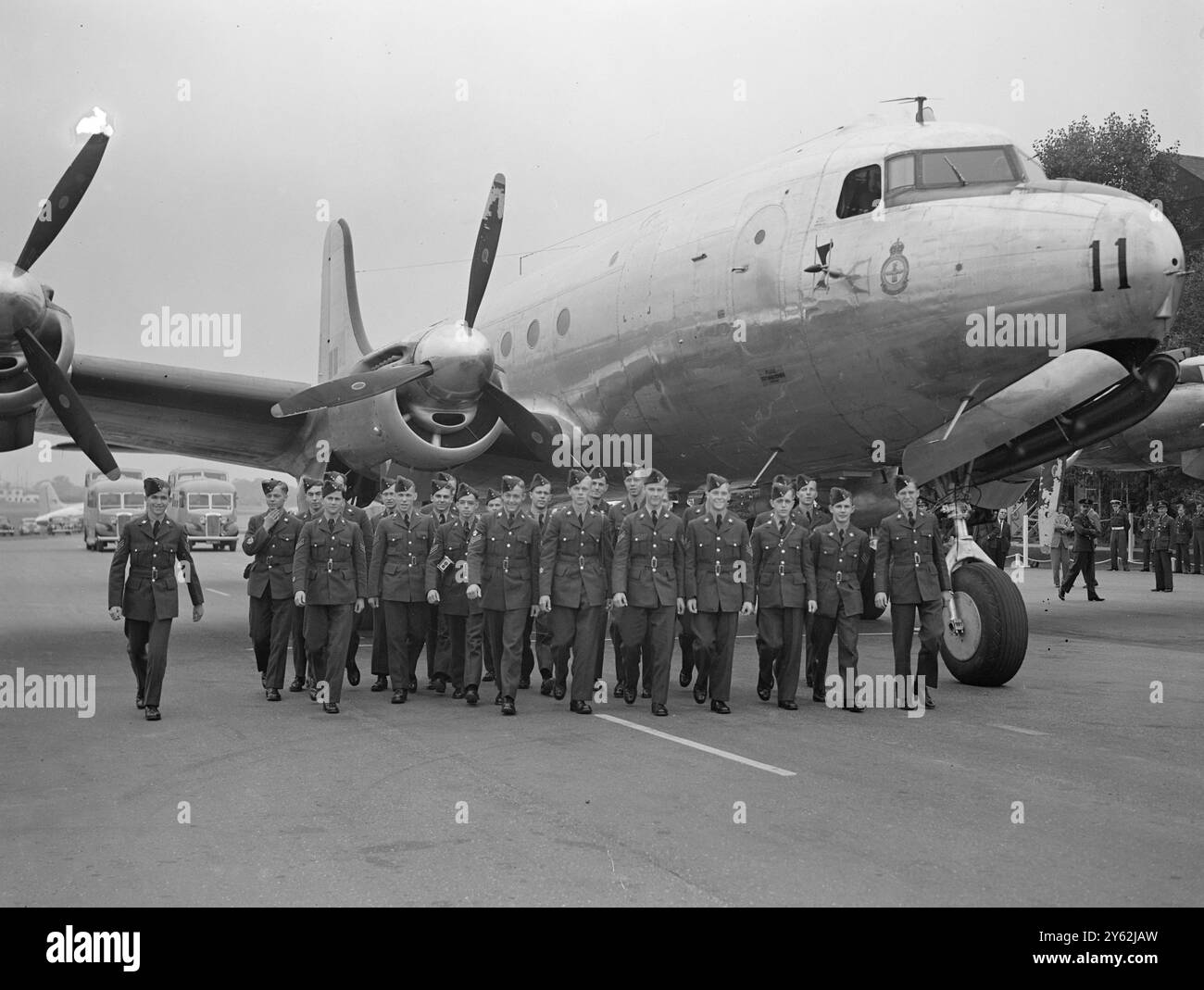 'Maple Leaf' Cadets arrive by air. Twenty-five Canadian ATC Cadets arrived at Northolt today, in an RCAF 'North Star' aircraft, the type adapted by Canadair for service as British airliners. The cadets are here on an exchange visit scheme and next Friday British ATC Cadets will fly to Canada in the same aircraft.  Picture shows: The cadets with aircraft in background at Northolt today  4 August 1948 Stock Photo