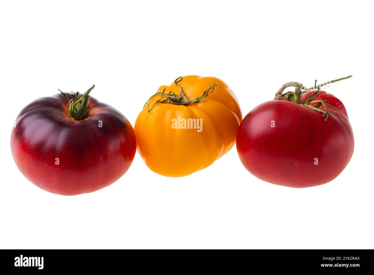 Close-up of three colorful heirloom tomatoes isolated on white background. Stock Photo