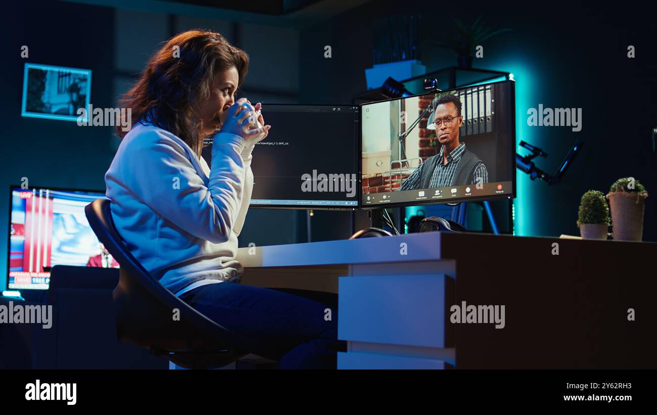 Software engineer teacher doing online tutoring, talking with student in online videocall about ways to do debugging. IT master teaching apprentice in webinar how to write code, camera B Stock Photo