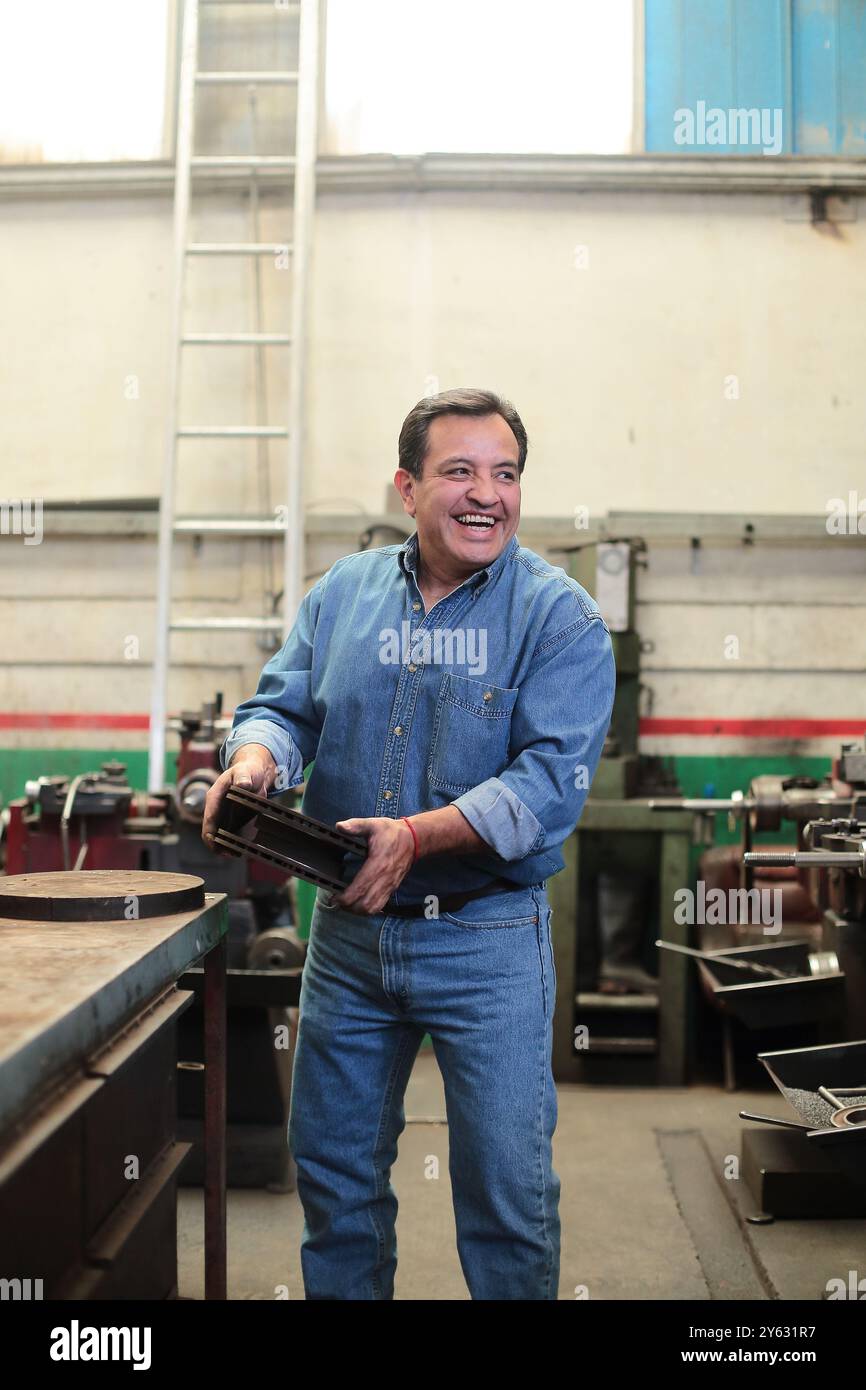 Smiling mechanic loads brake discs for delivery Stock Photo