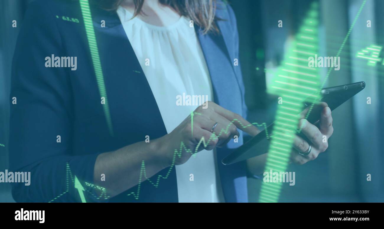 Analyzing financial data over businesswoman using tablet Stock Photo
