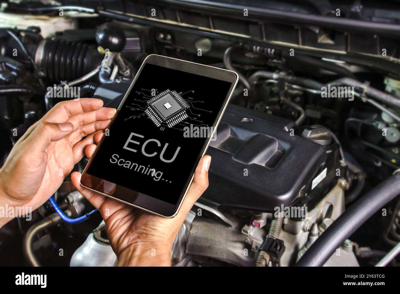 Technician checking the car electronic control unit system or ECU with ...