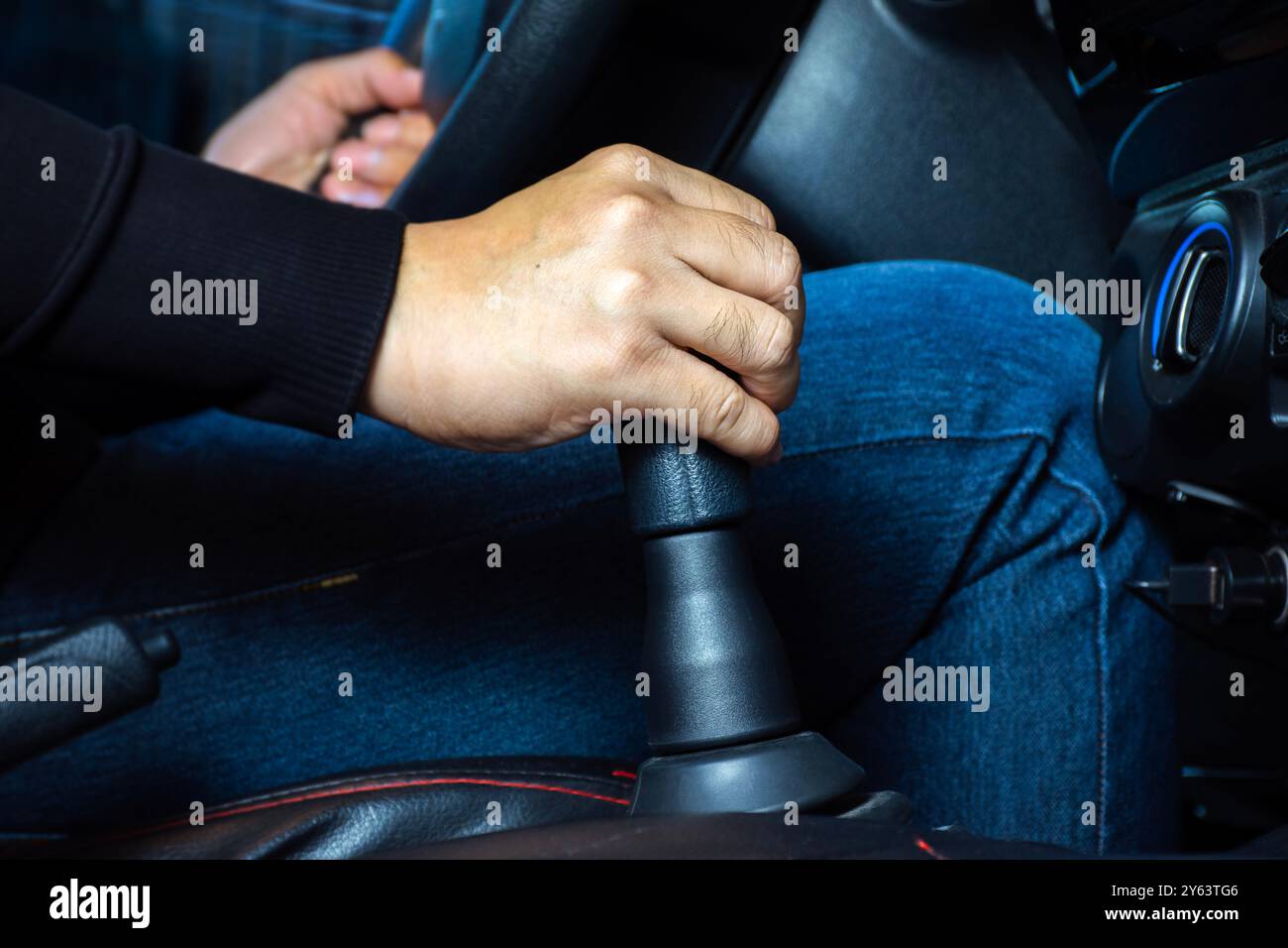 Drive a manual transmission car , Close up of driver hands changing gears in the car manual transmission Stock Photo