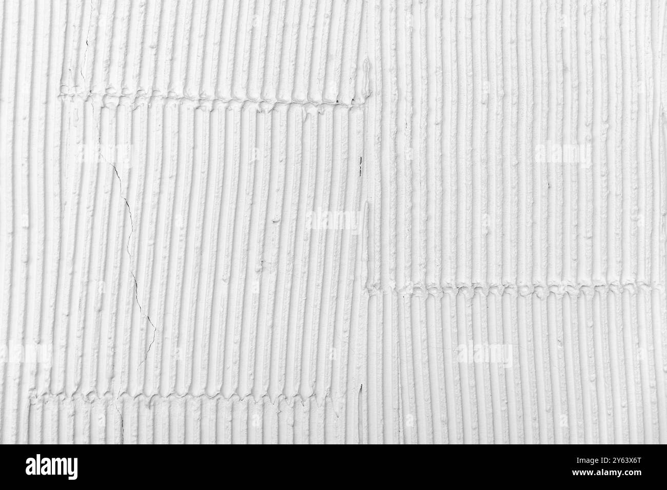 White wall with decorative stucco relief pattern. Front view, background photo texture Stock Photo