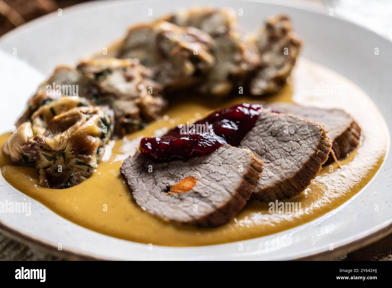 Beef fillets from sirloin steak with traditional Czech sauce, Karlovy Vary dumpling with cranberries and good Czech beer. Stock Photo
