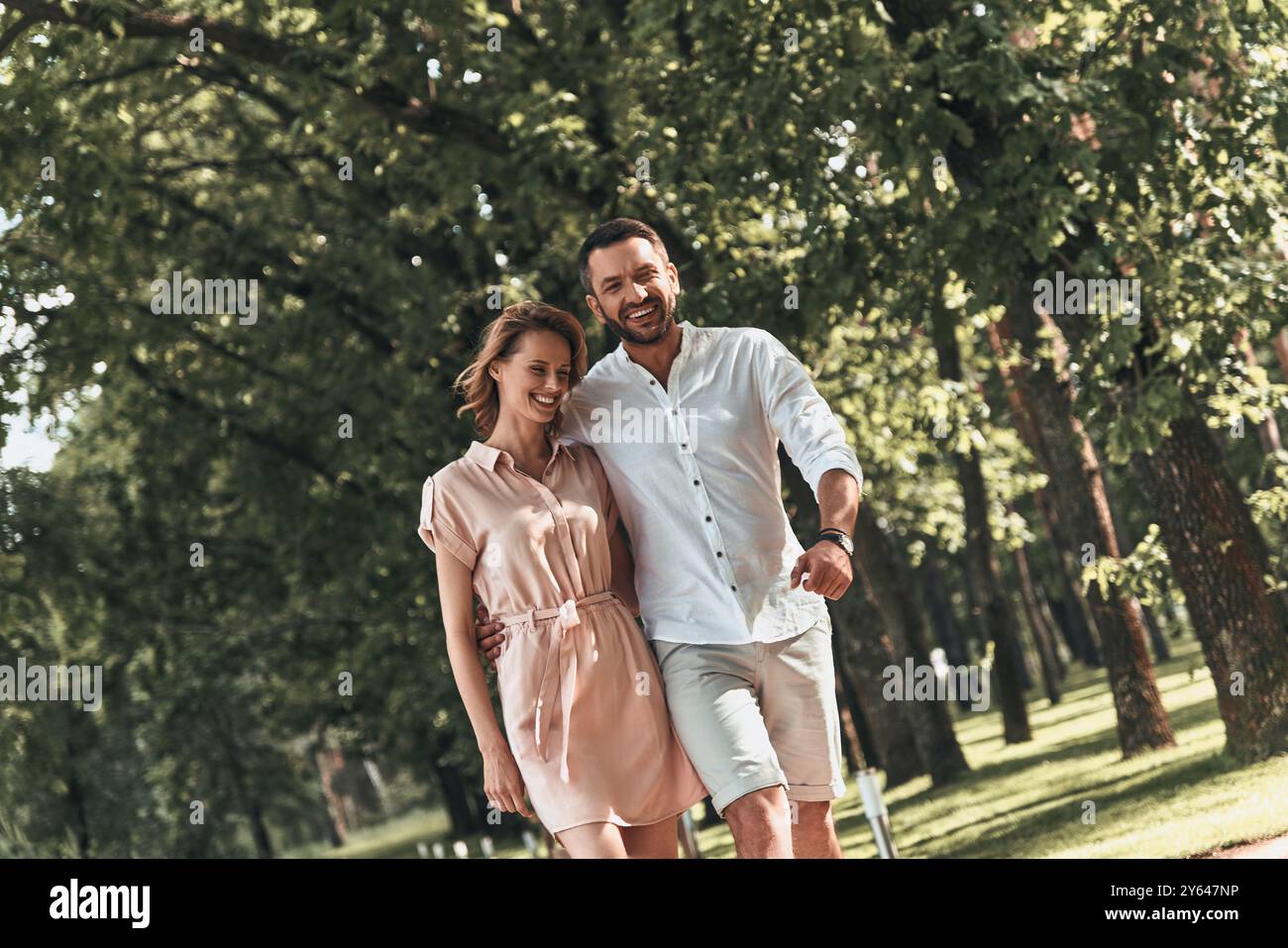 Real love. Beautiful young couple bonding and smiling while walking in the park together Stock Photo