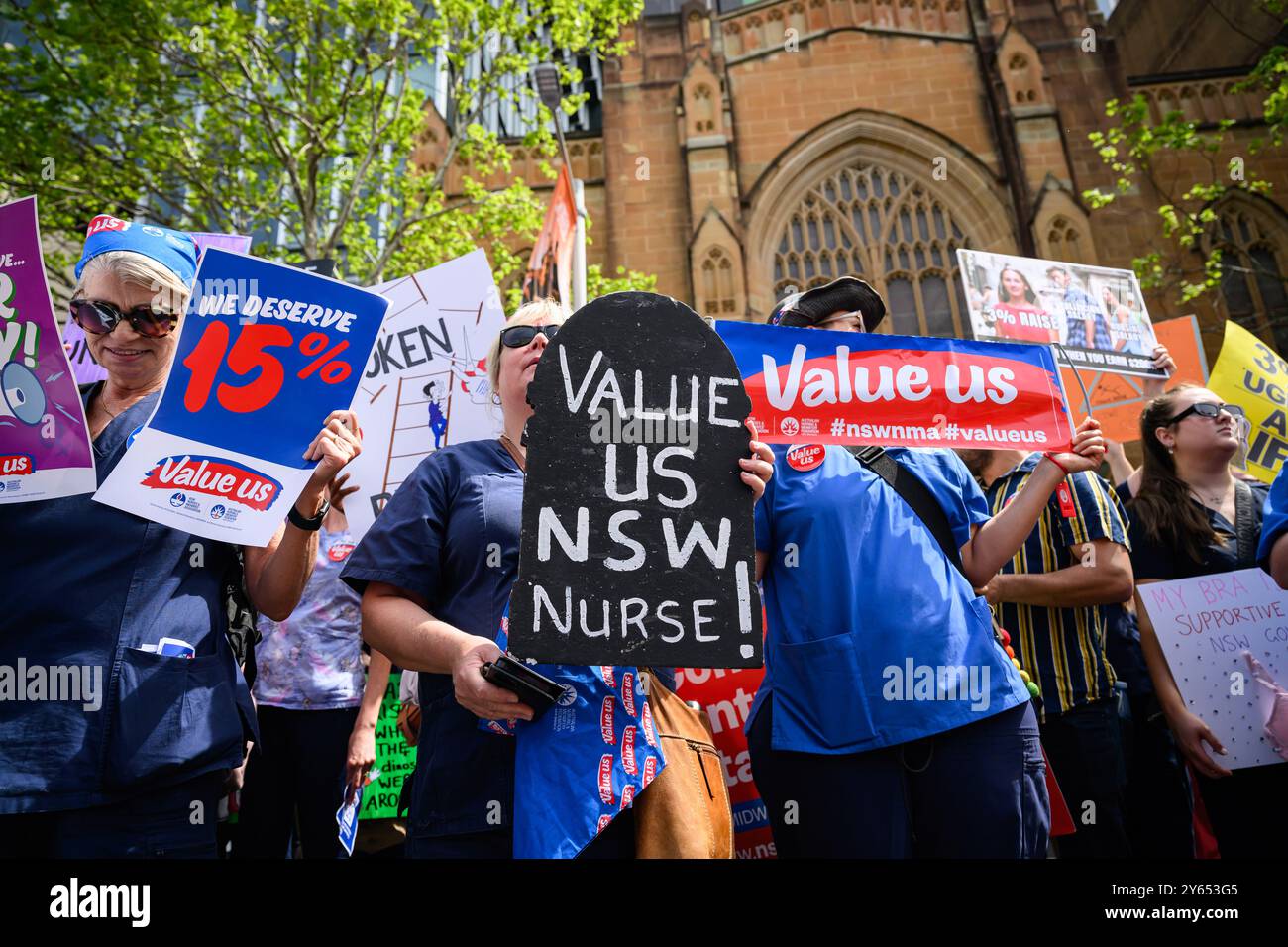 Sydney, Australia. 24th Sep, 2024. A Protester seen holding a placard that says ''We deserve 15%'' and ''Value us NSW nurse!'' during the rally in front of NSW Parliament. Nurses and midwives across New South Wales went on a 24-hour strike and marched from Hyde Park through Sydney's streets to NSW Parliament demanding a better pay rise. The association is calling for a 15% pay increase, while the government has only offered 3% (Credit Image: © George Chan/SOPA Images via ZUMA Press Wire) EDITORIAL USAGE ONLY! Not for Commercial USAGE! Stock Photo