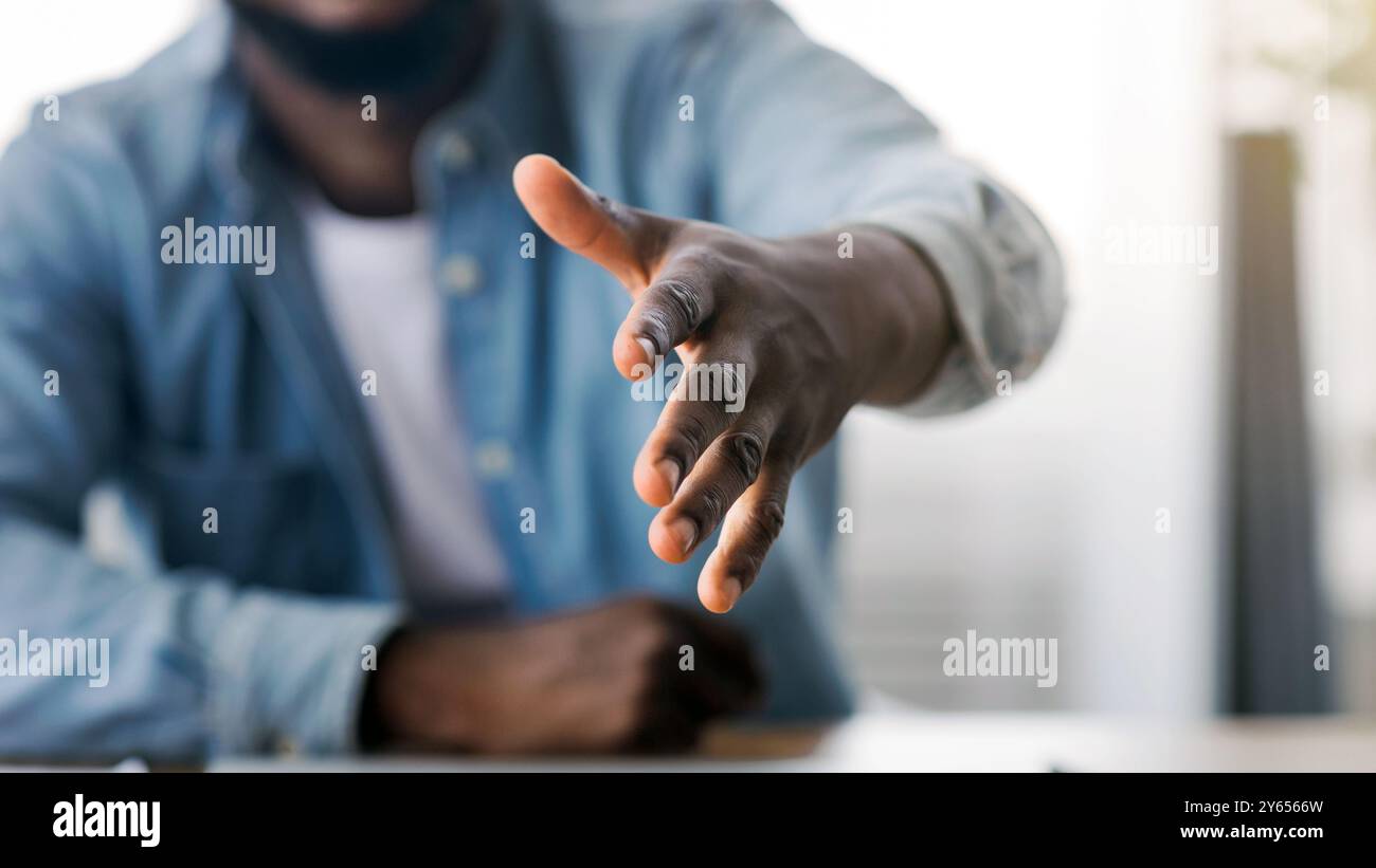 HR manager extending hand for handshake after successful job interview Stock Photo