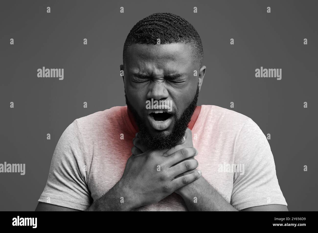 Young man having acute pain in throat Stock Photo