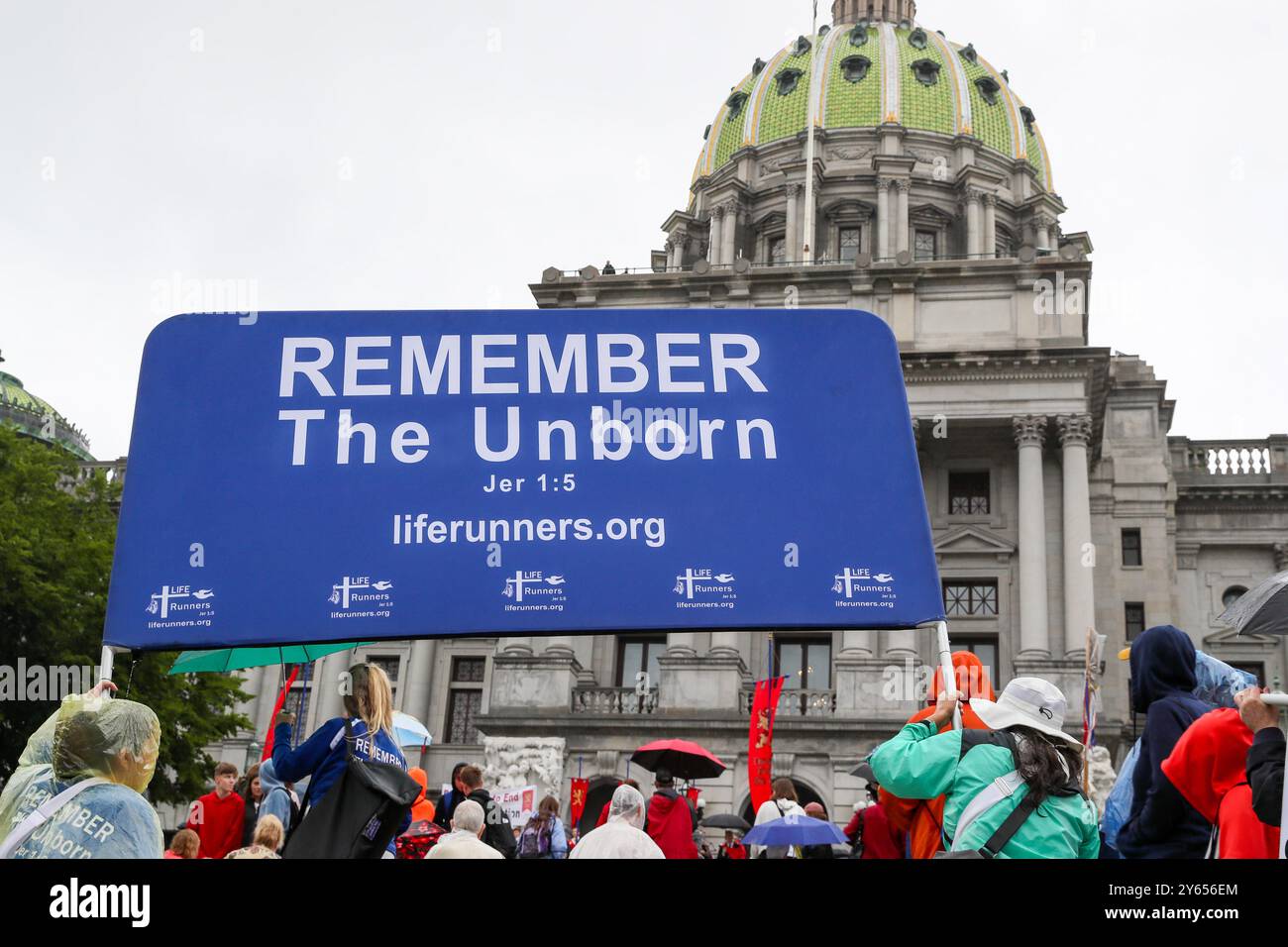 September 23, 2024, Harrisburg, Pennsylvania, United States: Members of the Liferunners organization hold a large banner in front of the Pennsylvania State Capitol during the Pennsylvania March for Life. Hundreds of abortion opponents gathered at the Pennsylvania Capitol for the fourth annual Pennsylvania March for Life. (Credit Image: © Paul Weaver/SOPA Images via ZUMA Press Wire) EDITORIAL USAGE ONLY! Not for Commercial USAGE! Stock Photo