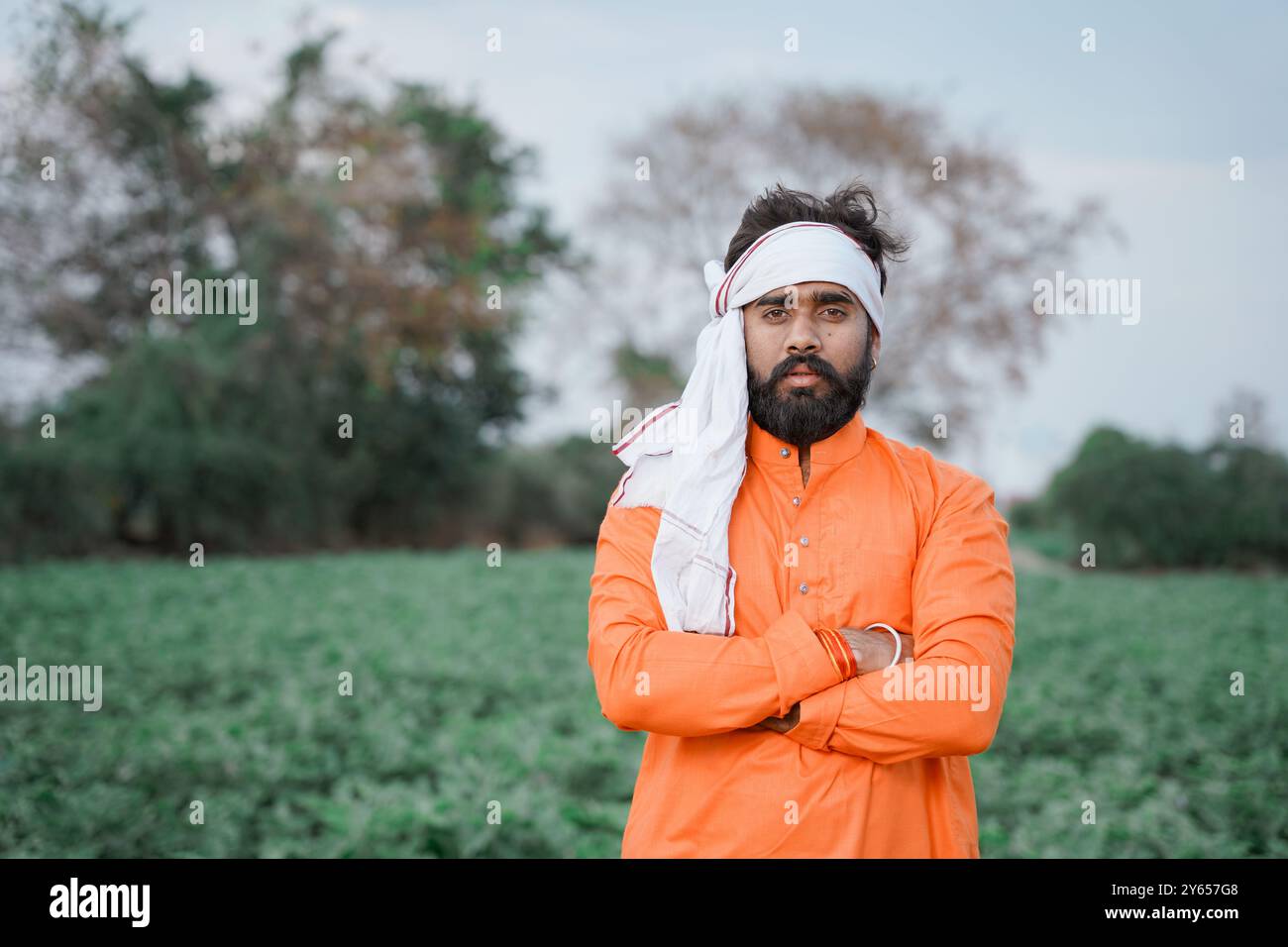 Indian farmer, young, standing on an agricultural field Stock Photo - Alamy