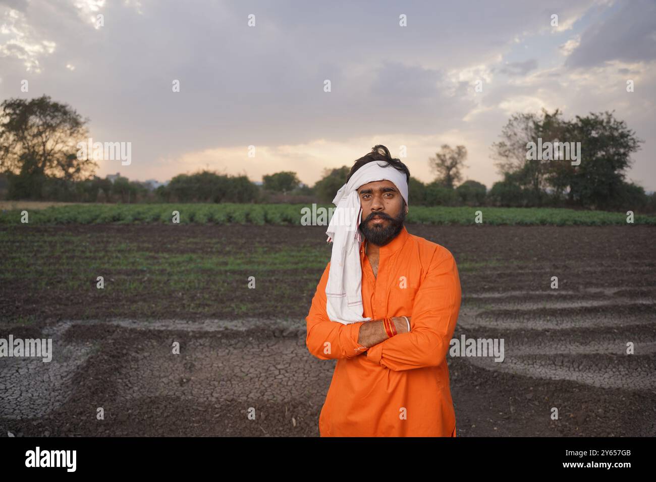 Indian farmer, young, standing on an agricultural field Stock Photo - Alamy