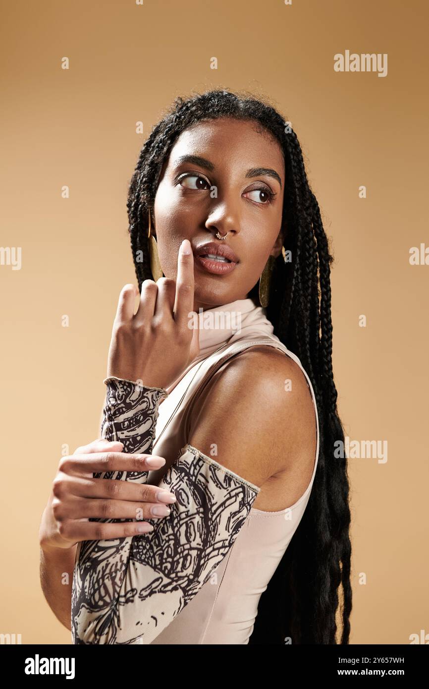 A stylish young woman poses gracefully, showcasing her unique attire ...