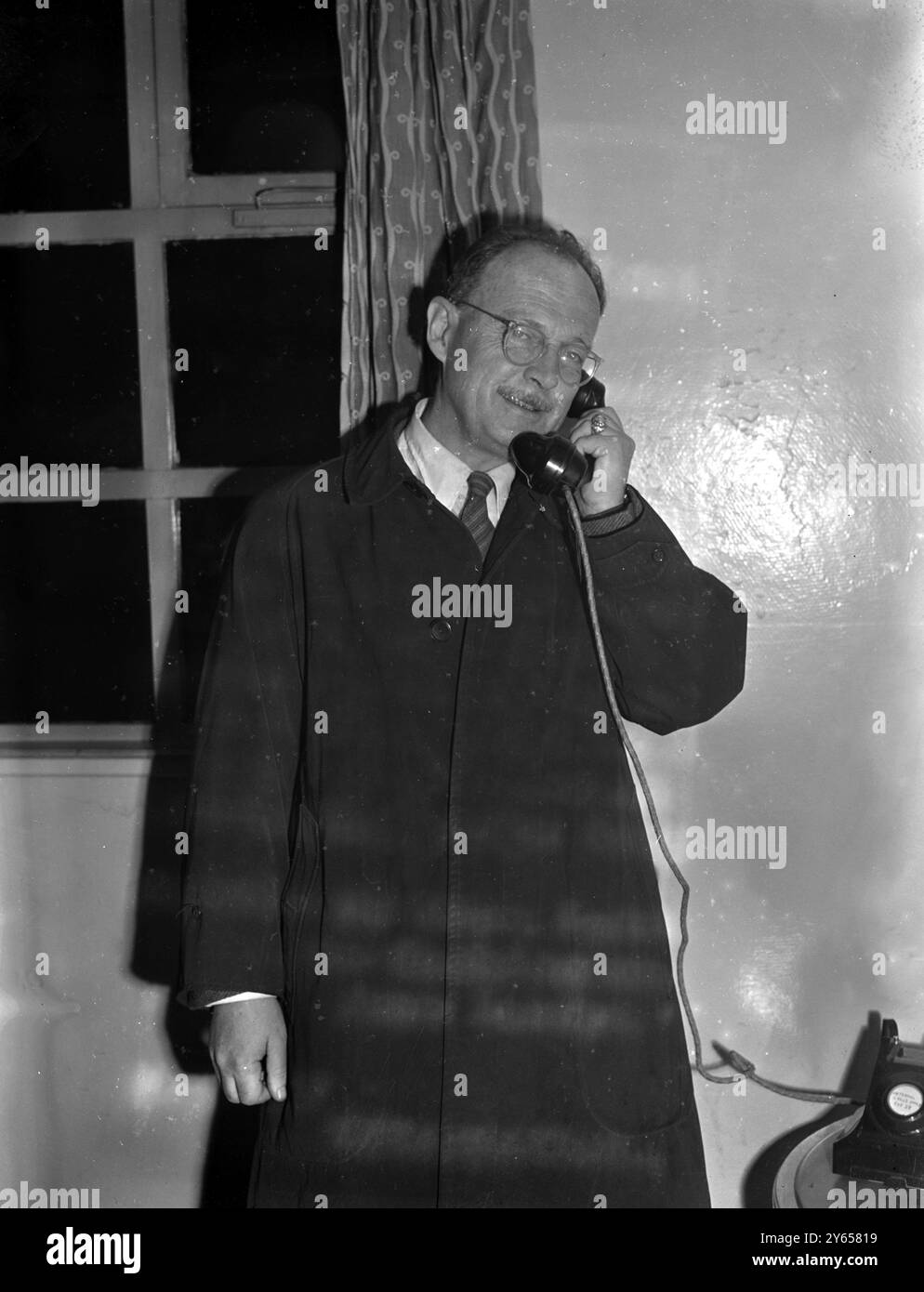 American flies home from Afghanistan to answer red charges. Owen J Lattimore, traveller , writer and lecturer on Eastern Affairs has become the centre of the storm now raging over the presence of Communists in the State Department .  Accused of being top Soviet agent in the US by witch-hunting Senator Joseph McCarthy  , Mr Lattimore is flying back to Washington to answer the charges which he describes as 'moonshine' .  This evening he passed through London Airport en route for the States.   Mr Owen Lattimore photographed talking to Washington from London Airport .  30 March 1950 Stock Photo