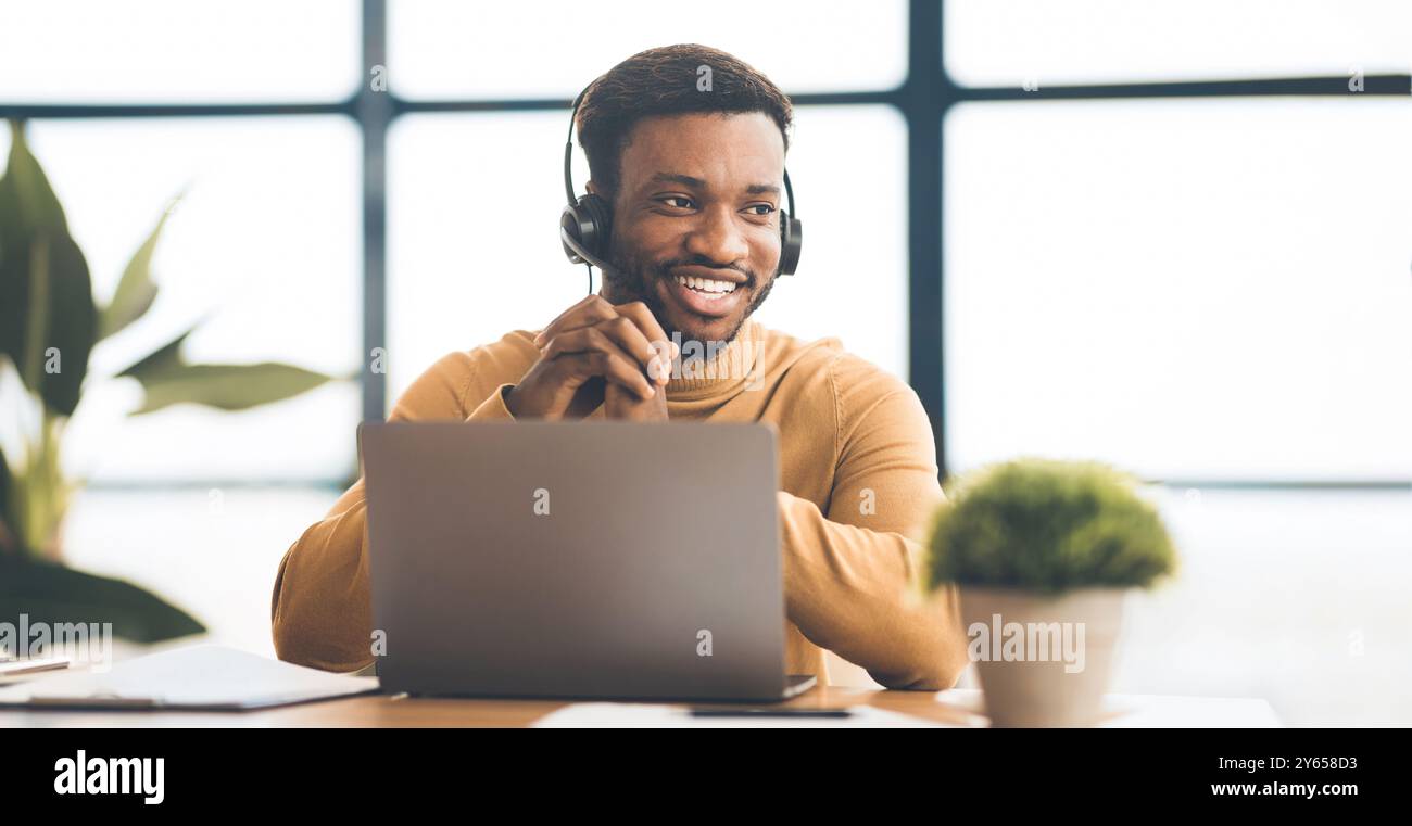 Happy afro manager working in call centre Stock Photo