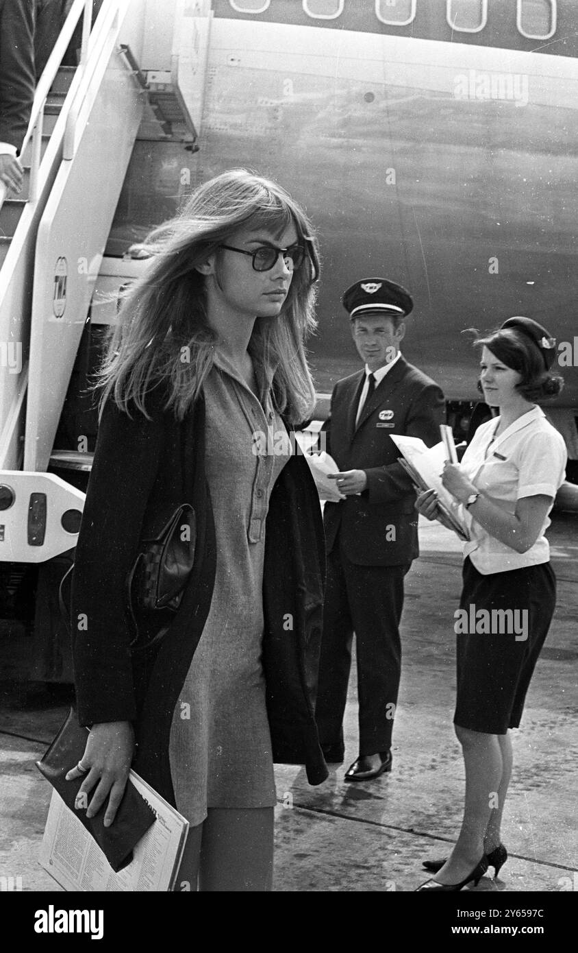 Girl with the shoulder length hair pictured at London Airport is one of Britain's top medels Jean Shrimpton arriving back from New York , USA . 21 July 1967 Stock Photo