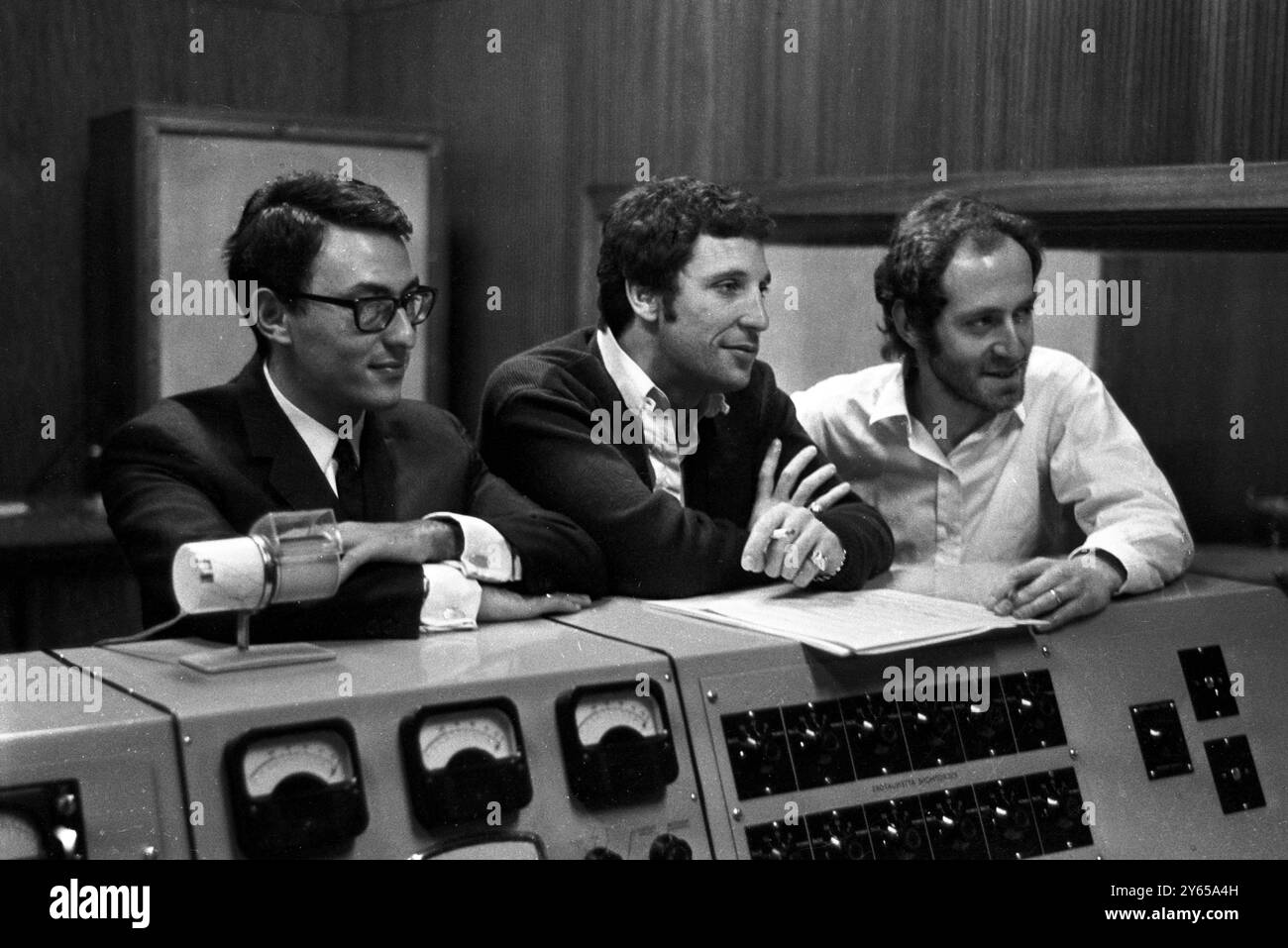British pop singer Tom Jones ( centre) at a West London recording studio today where he recorded the theme tune of the latest James Bond film, Thunderball.   At left is Jones' manager Gordon Mills and right John Barry who has composed nearly all the Bond film theme tunes. The film is due for release in December and will also be available on record with Jones singing the theme  12th October 1965 Stock Photo