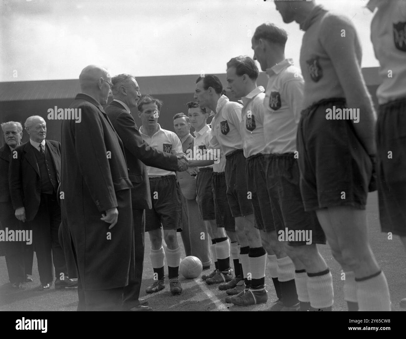 Lord Wigram shaking hands with the Willington team as the players were presented to him before the kick-off in the FA Amateur Cup Final between County Durham teams Willington and Bishop Auckland , Empire Stadium , Wembley 22nd April 1950 Stock Photo