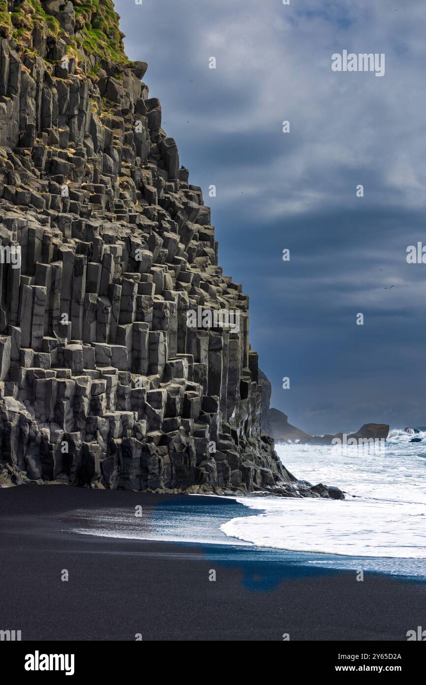 A scenic view of Reynisfjara Black Sand Beach with basalt columns and ...
