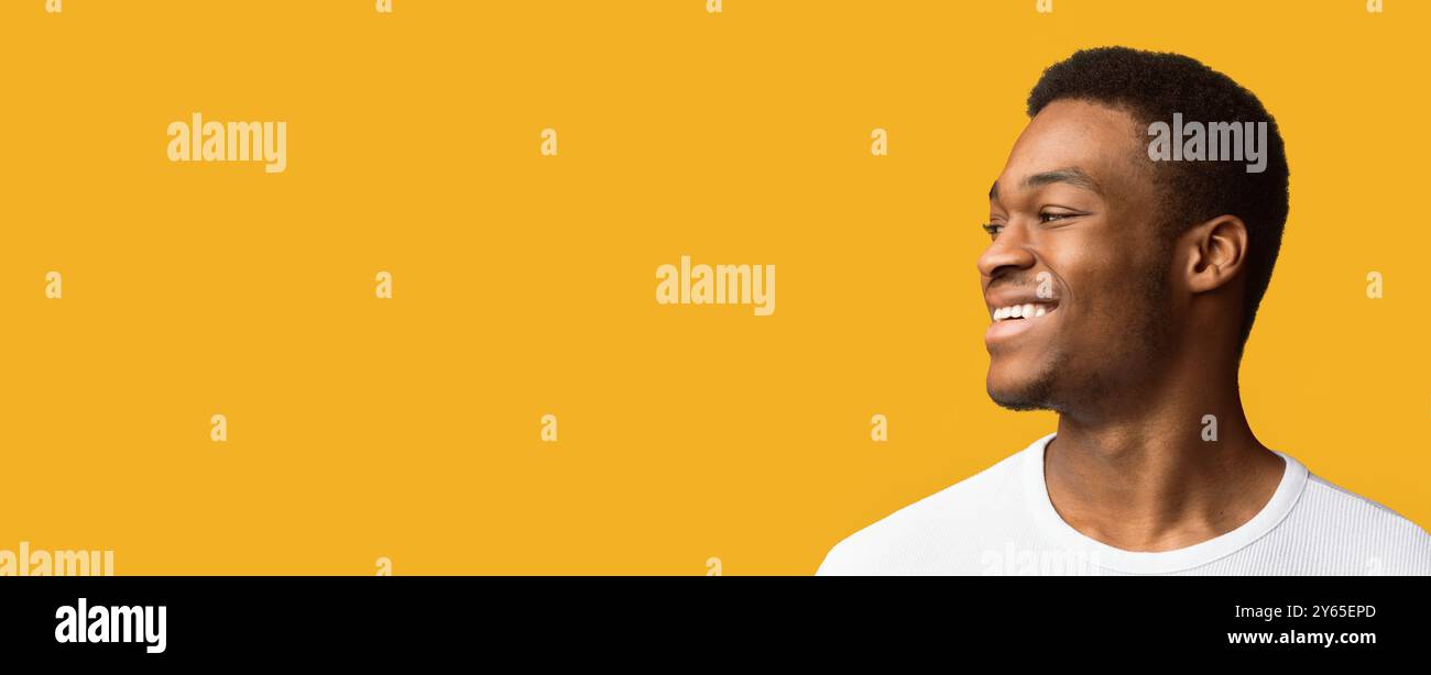 Happy black guy looking at free space Stock Photo
