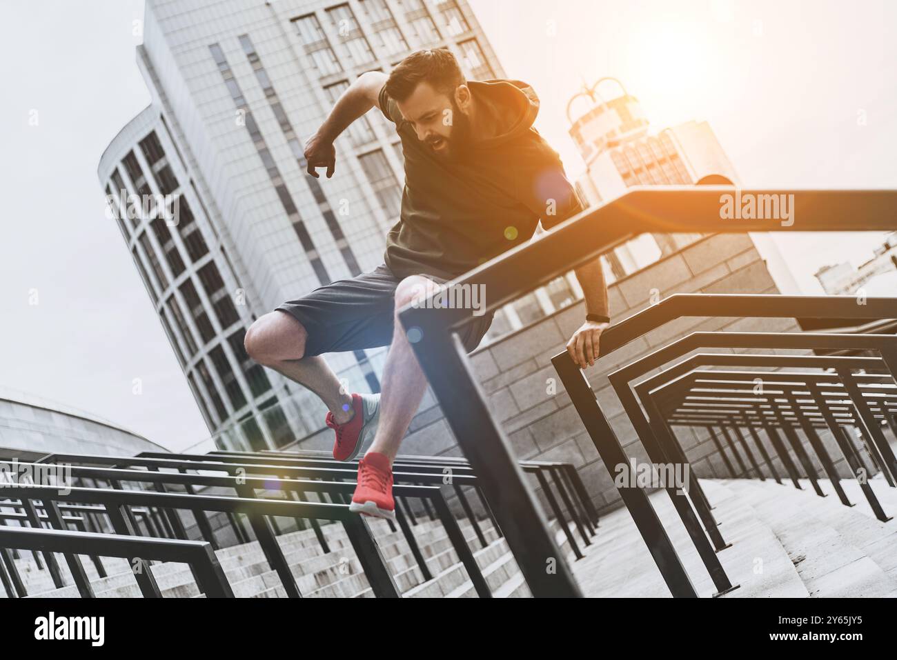 Young man jumping over railing hi-res stock photography and images - Alamy