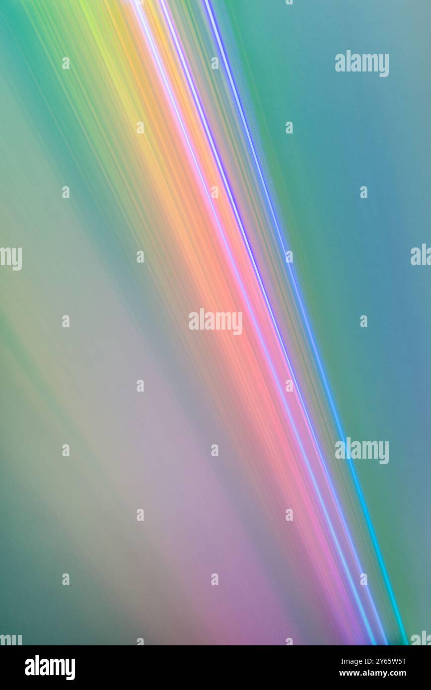 An abstract composition featuring vibrant, colored light streaks cascading across a soft gradient backdrop. Stock Photo
