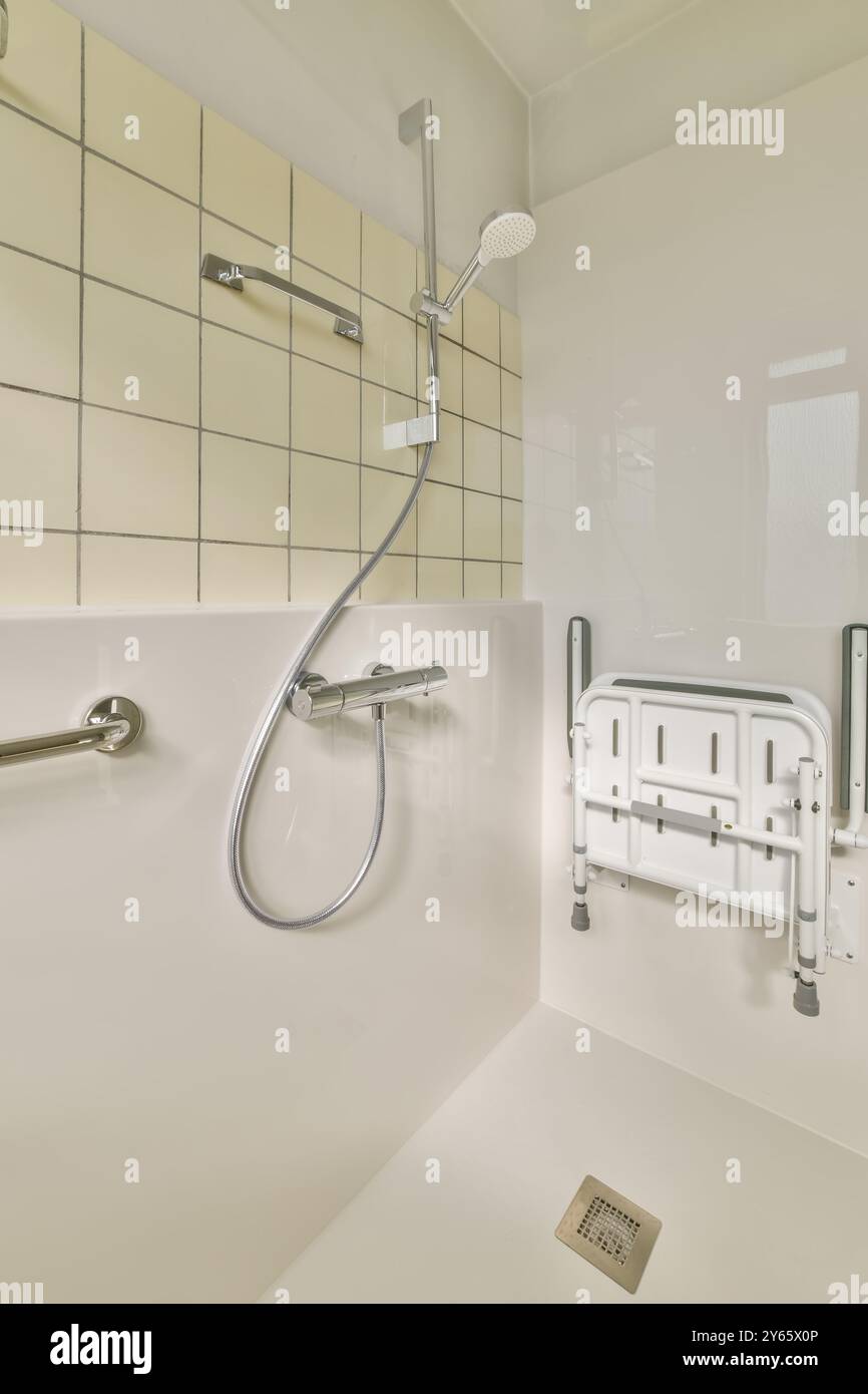 A well-equipped accessible bathroom featuring safety grab bars ...
