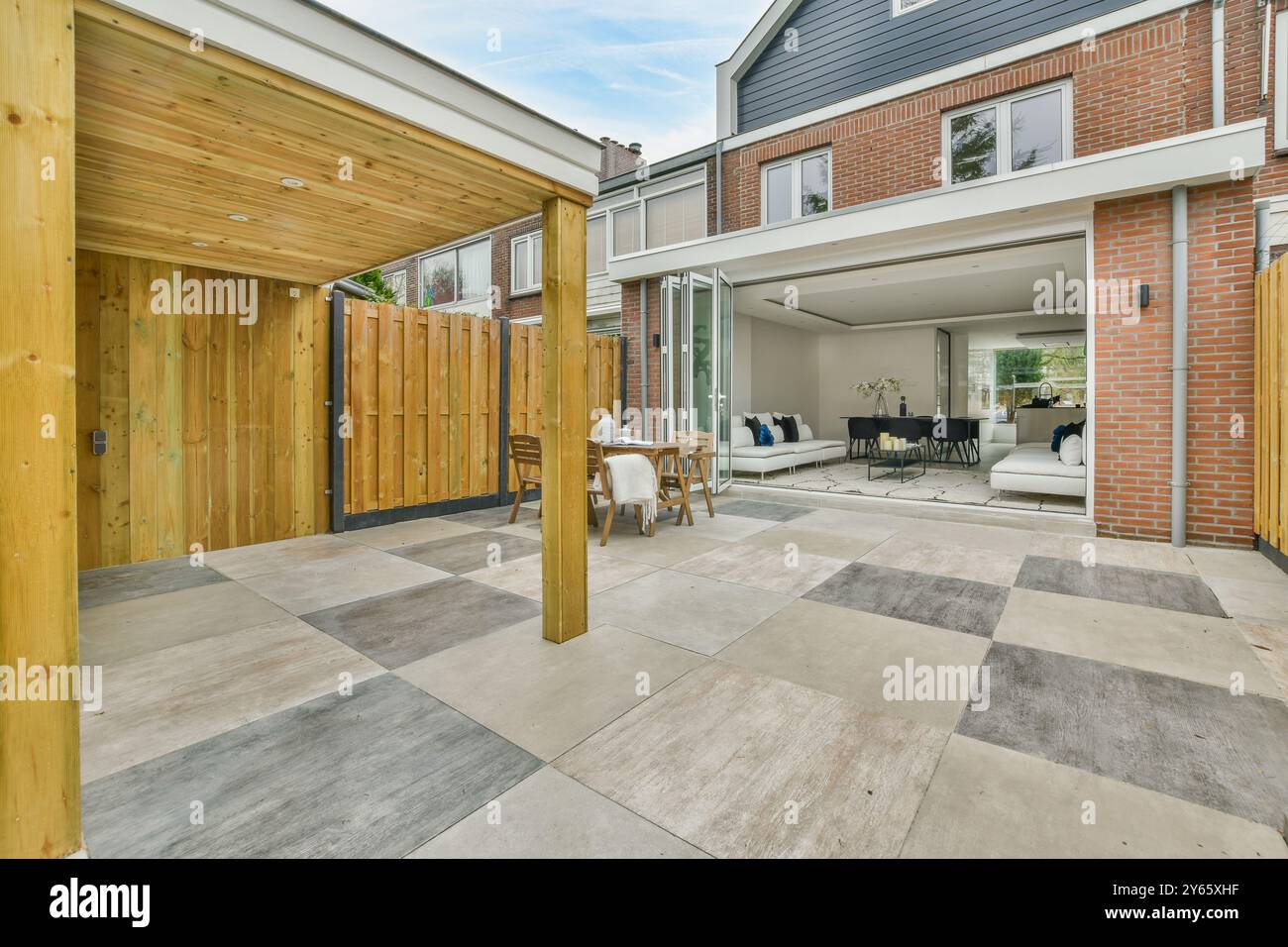 A modern home patio seamlessly transitions into an open-plan living ...