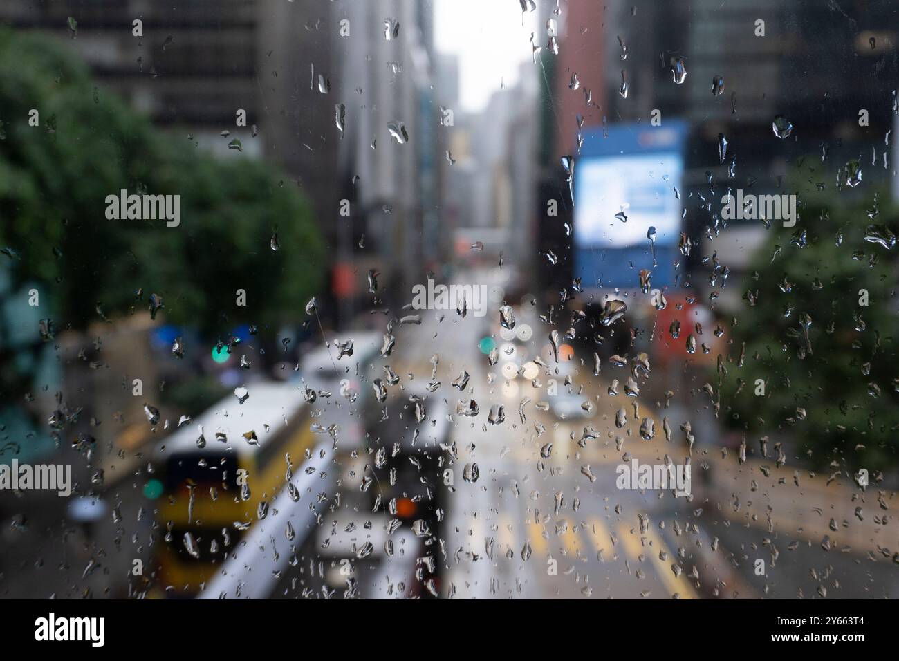 iconic street scene in Central Hong Kong, seen through window covered ...