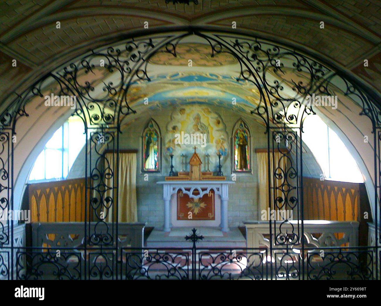 The Italian Chapel on Lambholm , Orkney  - built by Italian prisoners of war ( in Camp 60 ) captured in Africa during WWII . The central Madonna and Child was painted by artist Ghiocchetti .  It is flanked by stained glass windows depicting St Francis of Assisi and St Catherine of Sienna .  ©TopFoto / Alan Smith Stock Photo