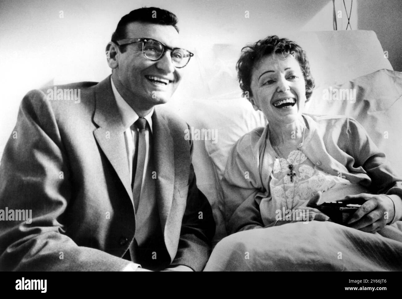 Edith Piaf in a New York hospital being visited by American pop singer Frankie Laine  5th April 1959 Stock Photo