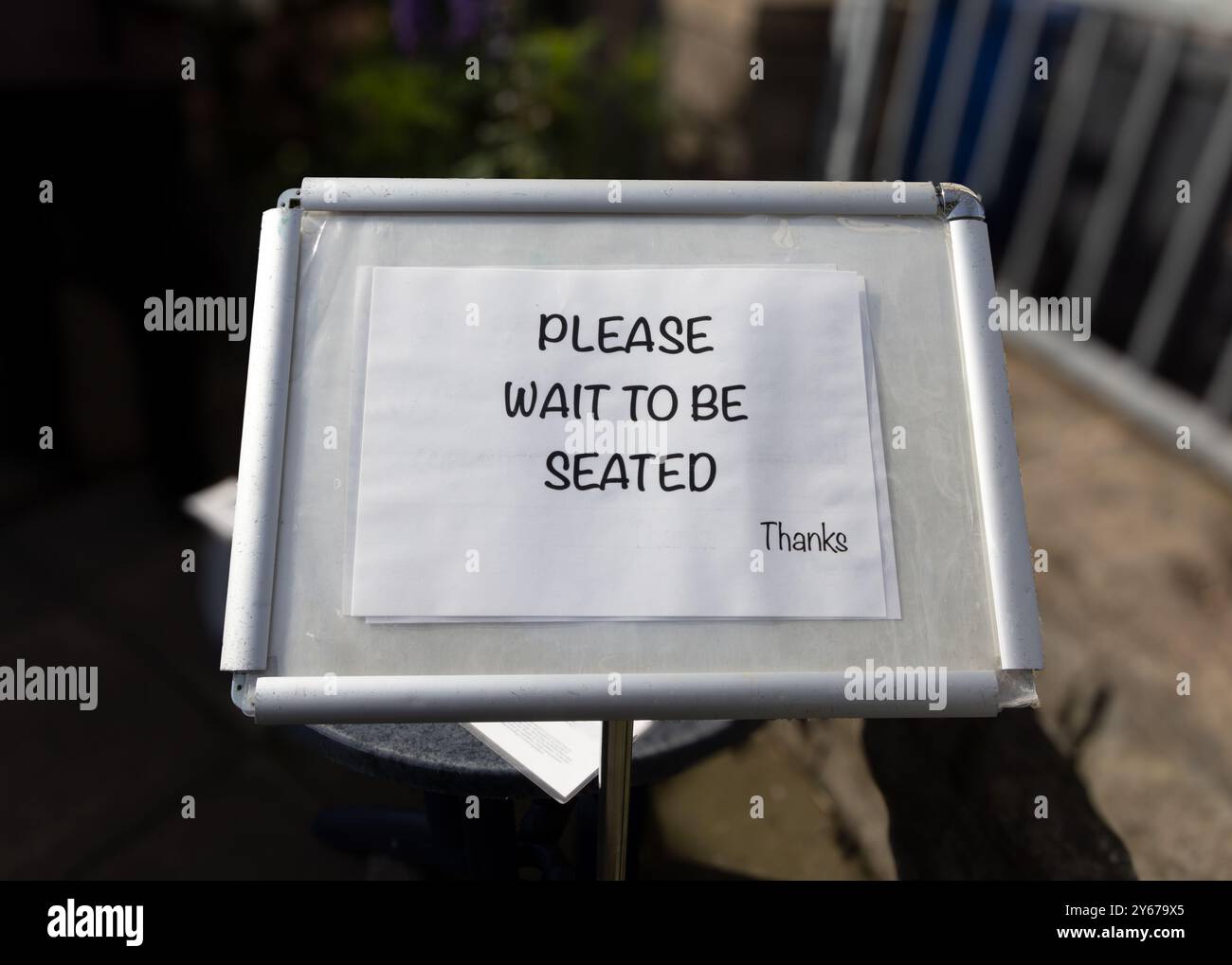 Please wait to be seated - restaurant sign in United Kingdom Stock Photo