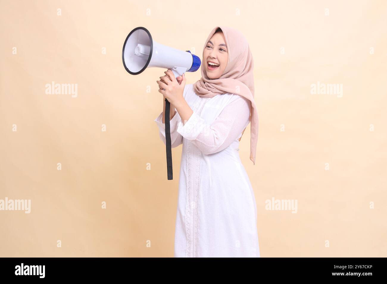 woman asian young wearing hijab slanted to the right candidly shouts ...