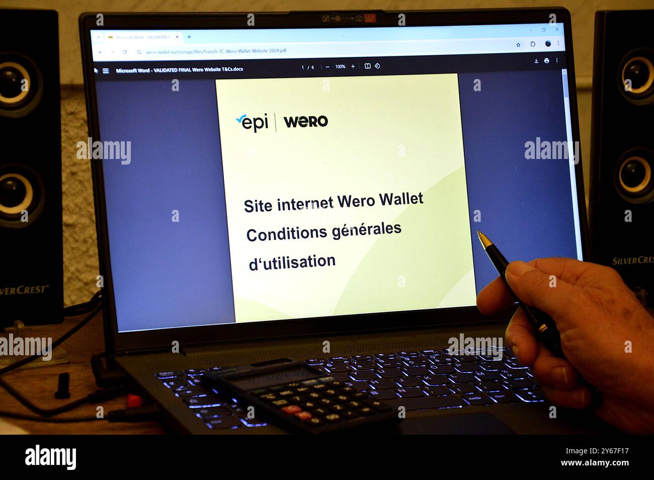 France. 24th Sep, 2024. In this illustration photo, a man holding a pen in his hand prepares to read the terms and conditions of use of the European payment application Wero, on his laptop. Created and developed by the European Payment Initiative (EPI), a private company owned by around fifteen European banks, the online payment service Wero (contraction of 'We euro') offers a smartphone application for all money transfers and online or in-store payments. (Photo by Gerard Bottino/SOPA Images/Sipa USA) Credit: Sipa USA/Alamy Live News Stock Photo