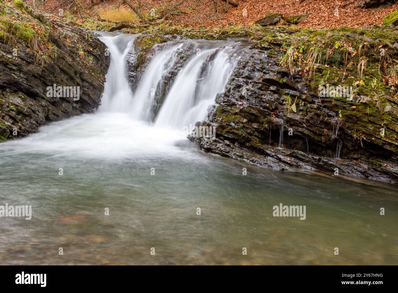 autumn scenery with waterfall. travel destination in carpathian mountains of ukraine. cascades of the river turychkain fall season Stock Photo