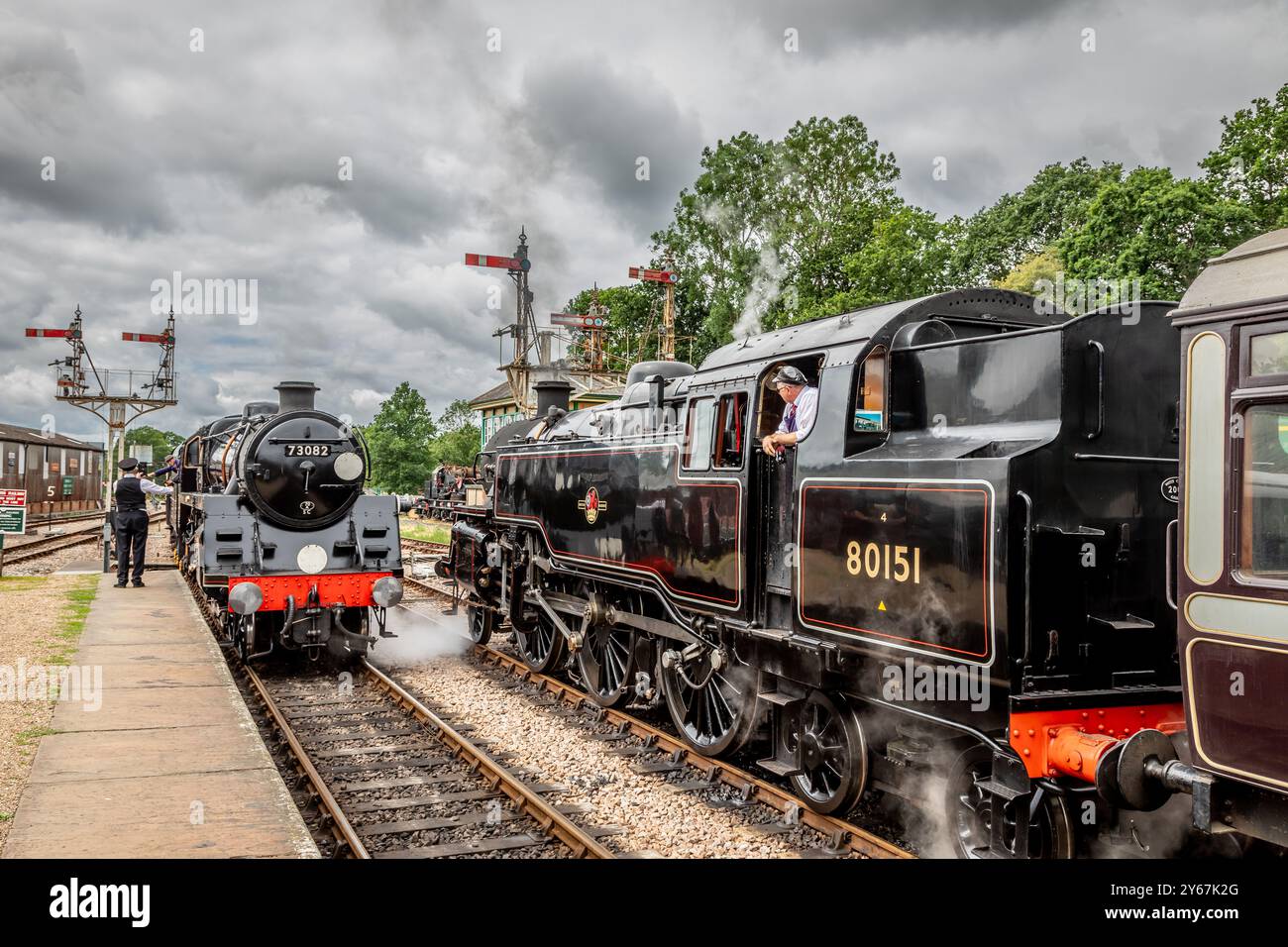 BR '5MT' 4-6-0 No. 73082 'Camelot' passes BR '4MT' 2-6-4T No. 80151 as ...
