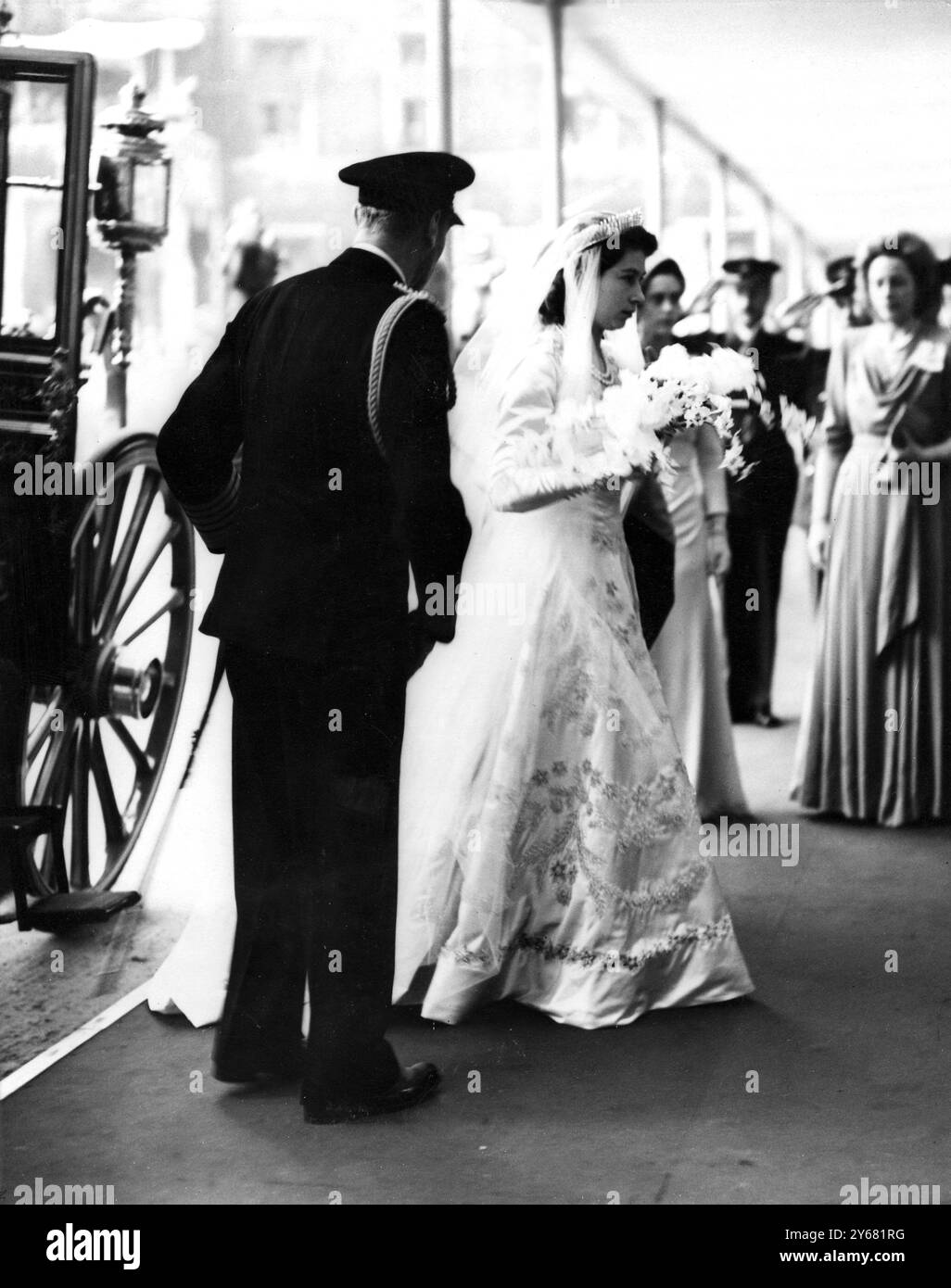 Princess Elizabeth wearing her shimmering pearl encrusted bridal gown arrives at Westminster Abbey with  His Majesty The King George VI for her wedding day. 20th November 1947. Stock Photo