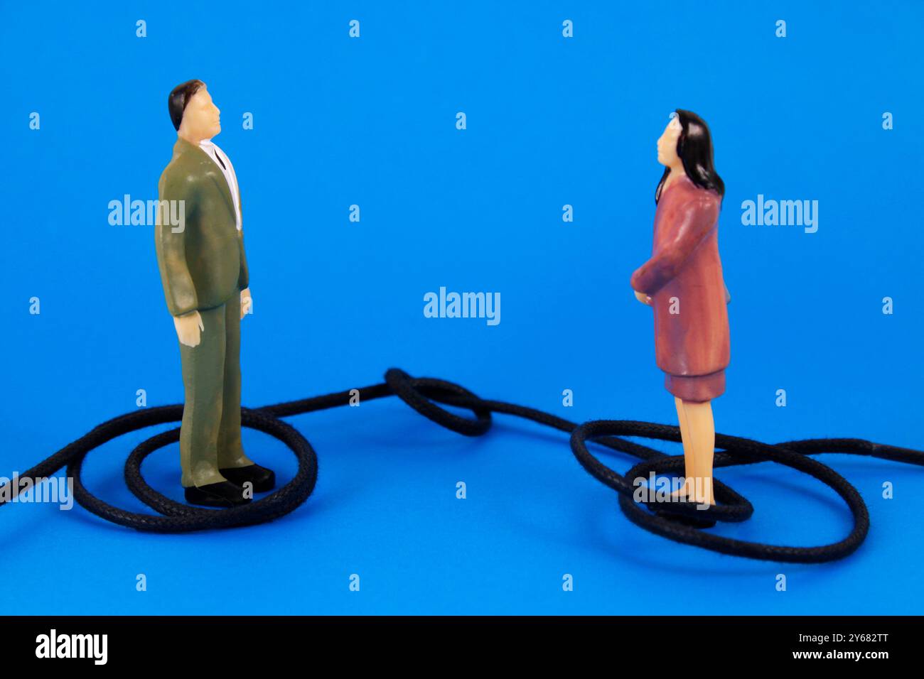 Rope with knot that traps man and woman who solve a work conflict Stock ...