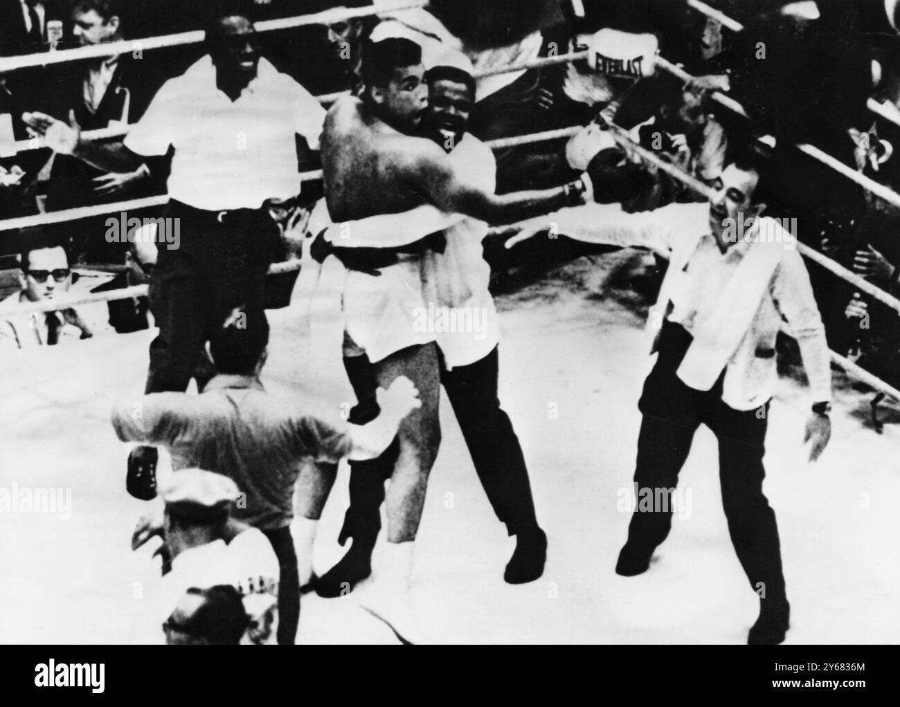 The new heavyweight champion, Cassius Clay and his handlers in after-fight jubilation in the ring following Clay's victory over former world champion, Sonny Liston in the 7th round of their title fight at Miami Beach, Florida. 25th February 1964. Stock Photo