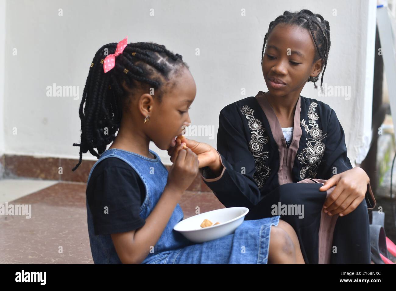 Cute lovely sisters outdoor having breakfast Stock Photo - Alamy
