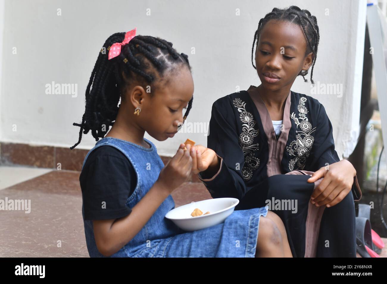Cute lovely sisters outdoor having breakfast Stock Photo - Alamy