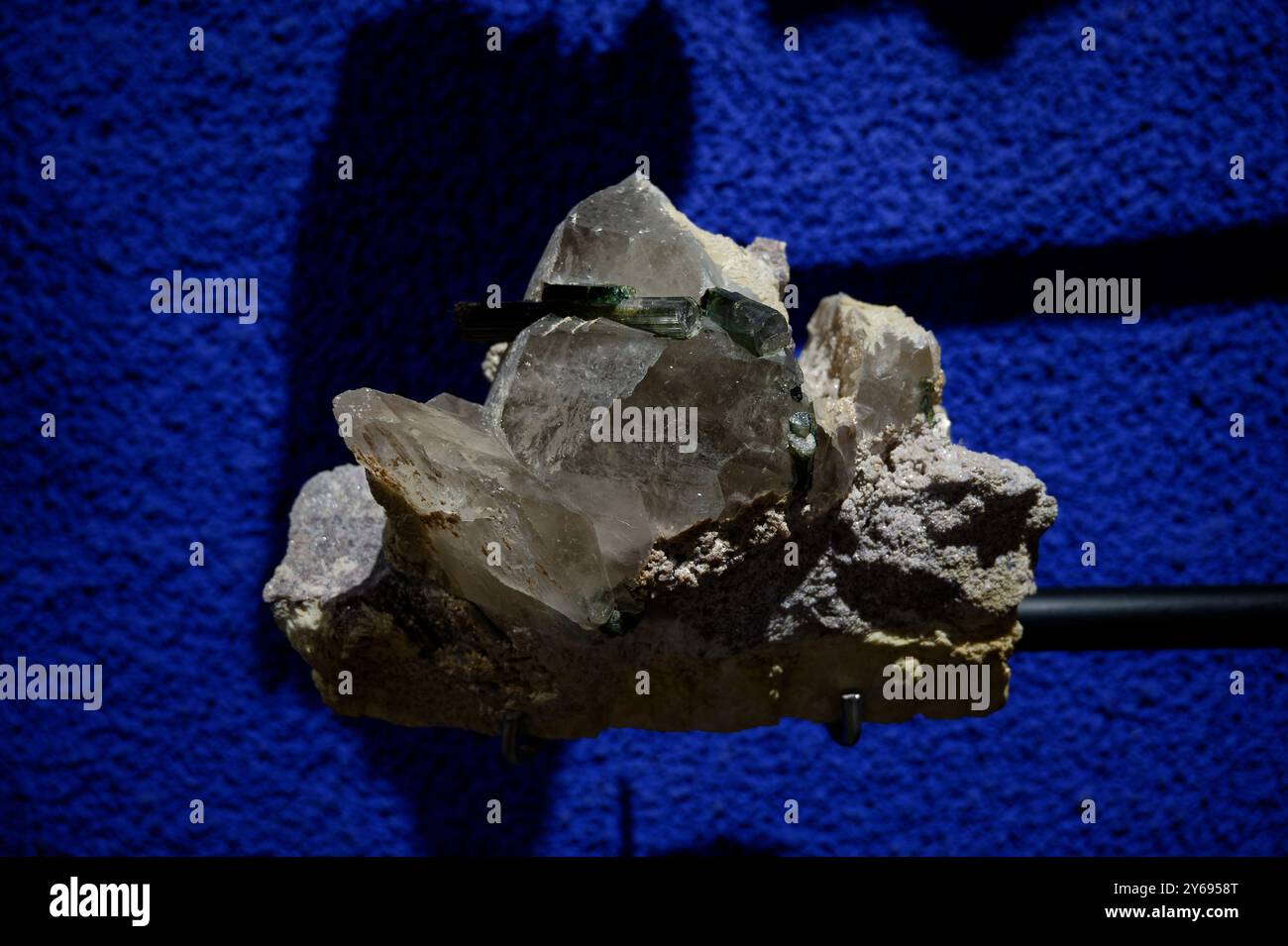 Crystal formation displayed against a striking blue background Stock Photo