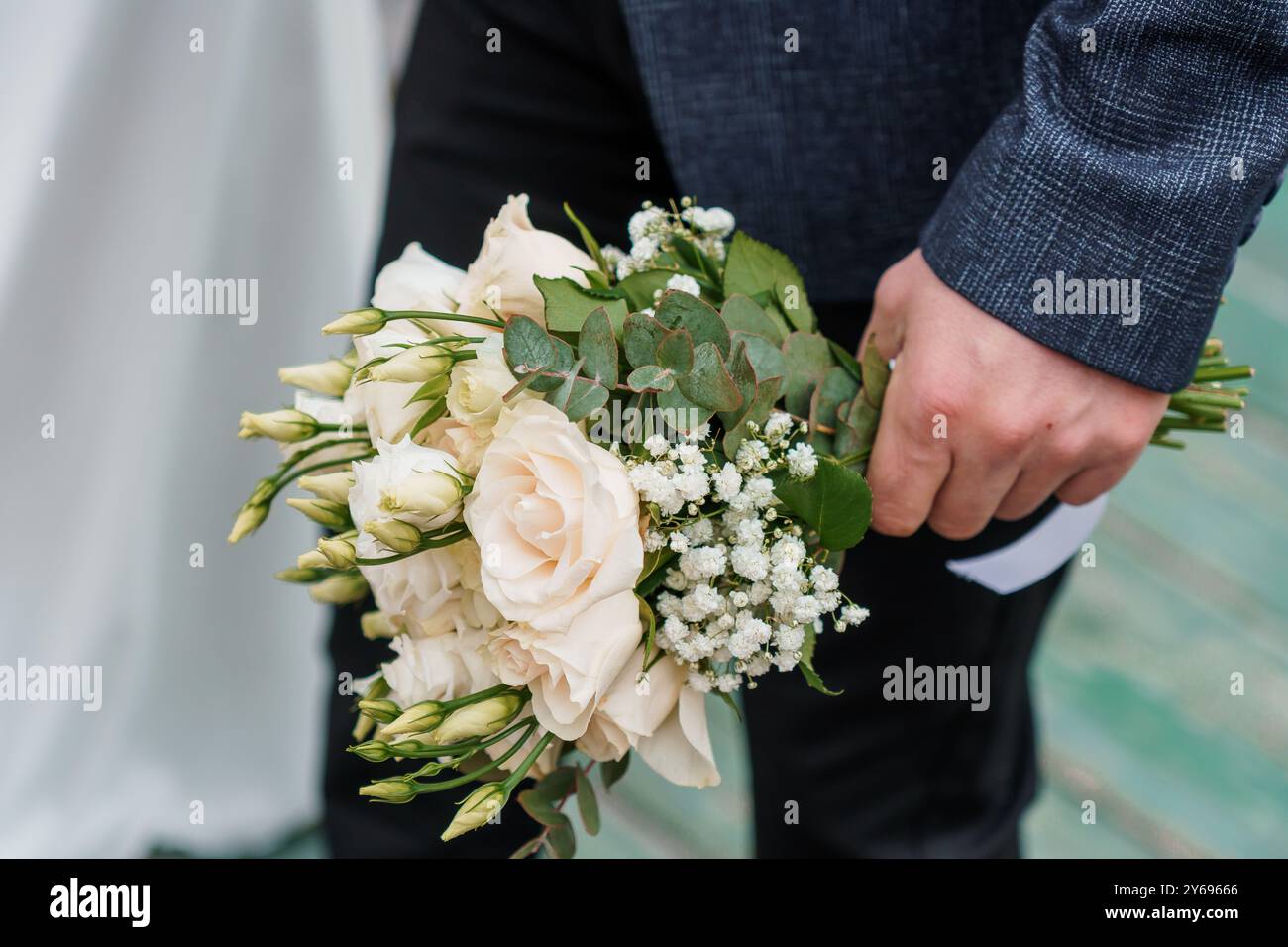 Elegant Bridal Bouquet with Soft Cream Roses and Lush Greenery in a ...