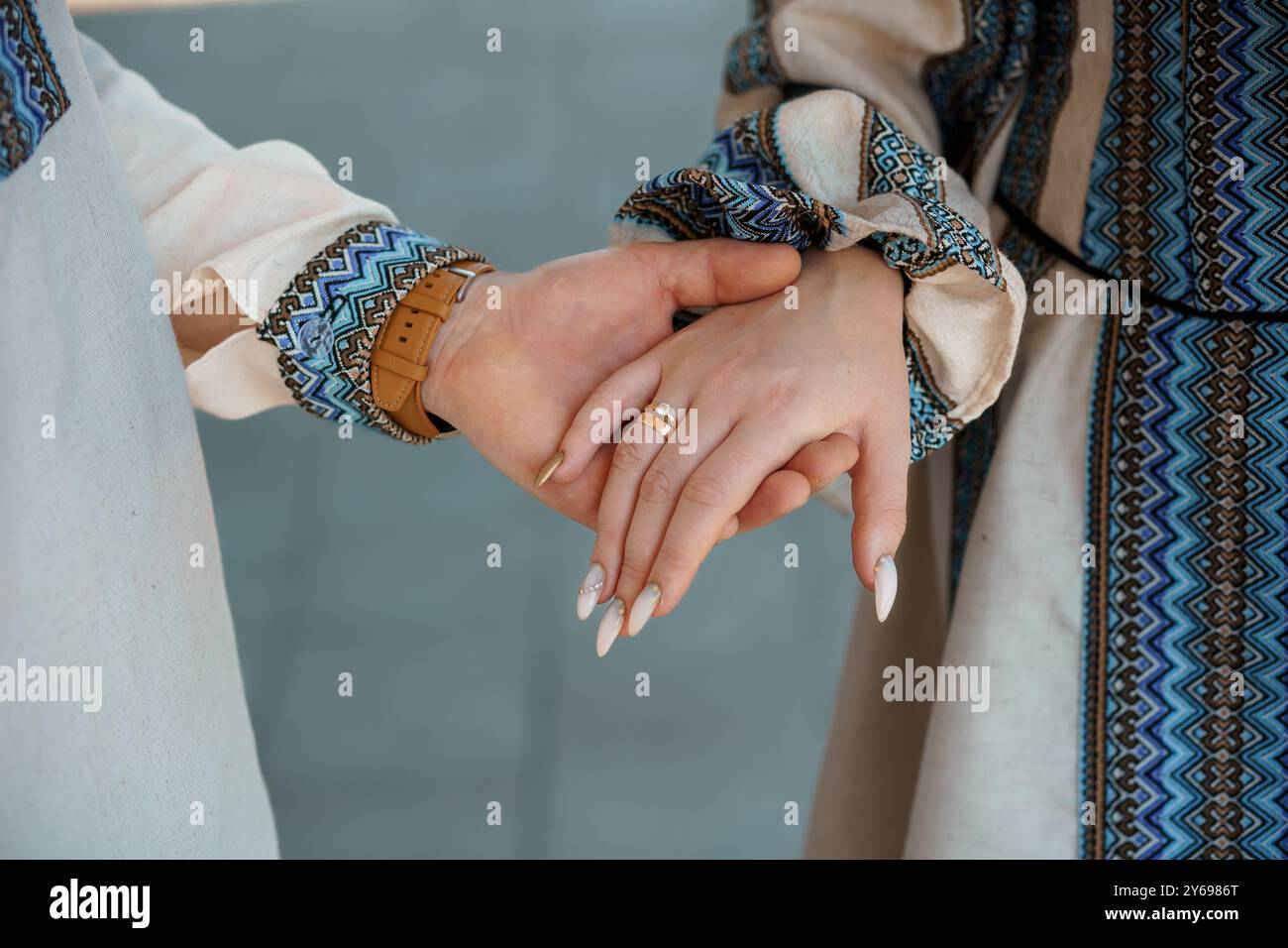 Intimate Pattern Intimate Moment: Elegant Hands of a Couple Wearing Traditional Attire ...