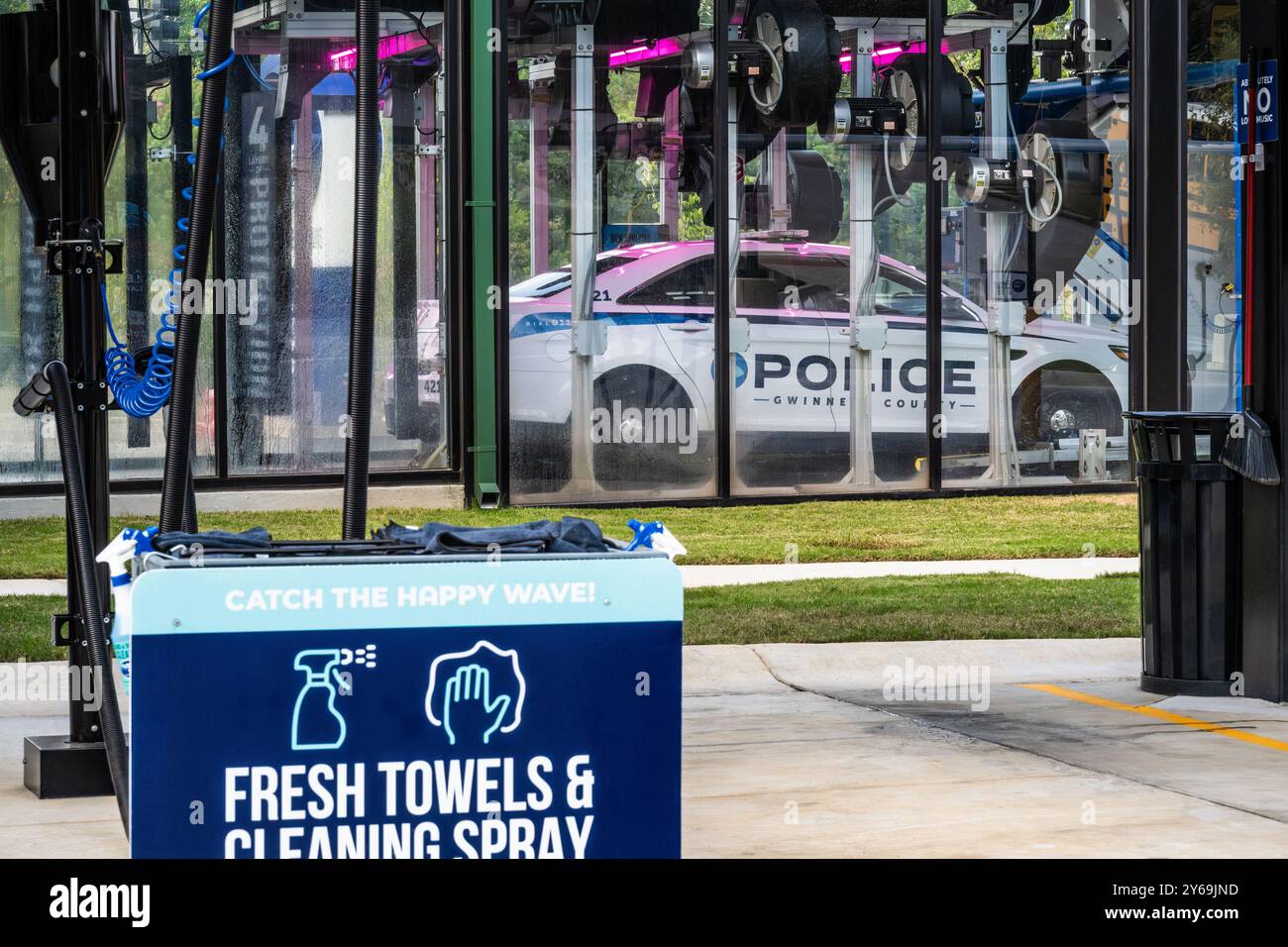 Gwinnett County police car going through an automated carwash at Tidal Wave Auto Spa in Snellville, Georgia. (USA) Stock Photo