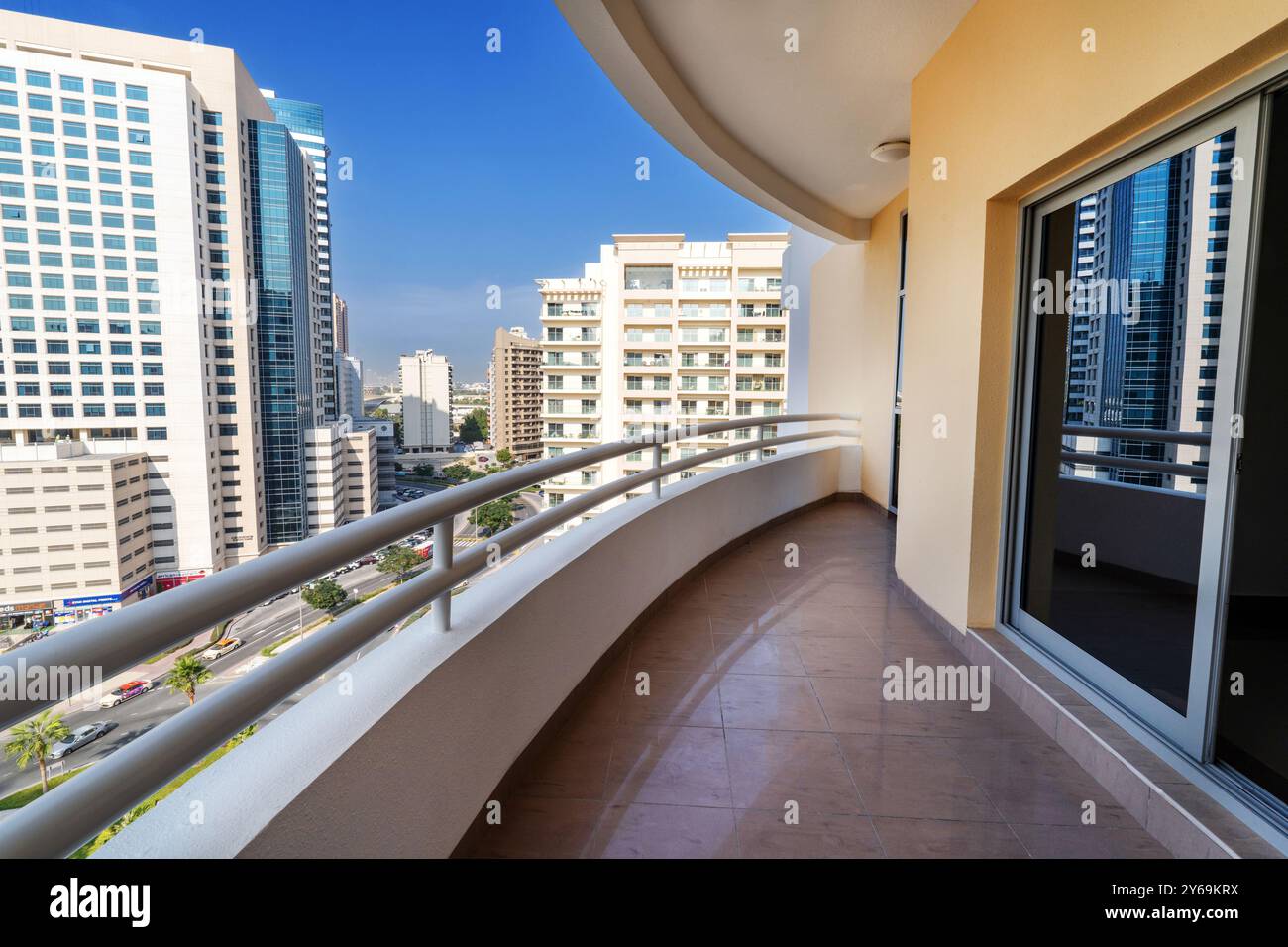 a modern balcony in Dubai with polished tiles and sleek railings. In ...