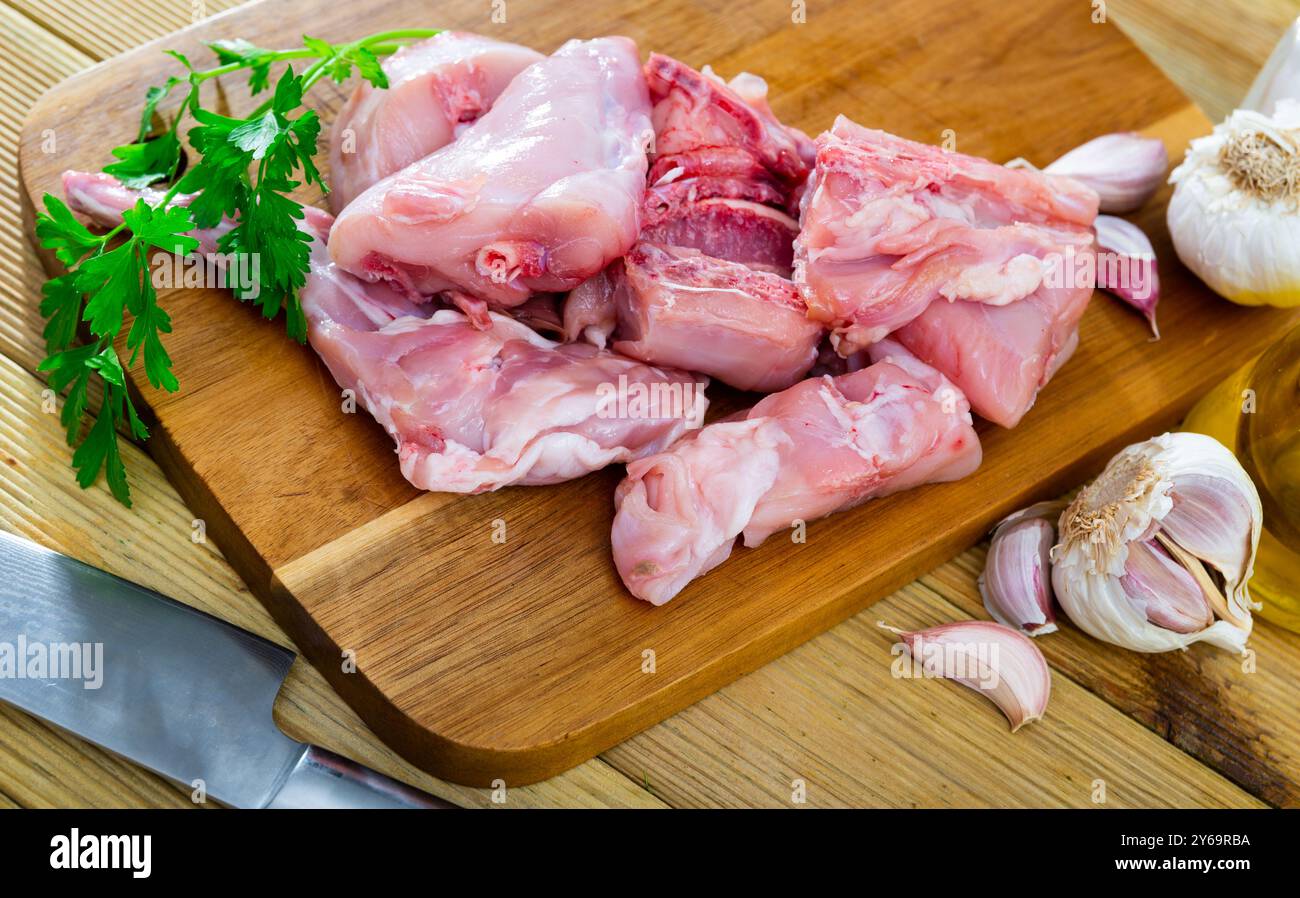 Portioned rabbit legs and saddle with herbs and spices Stock Photo