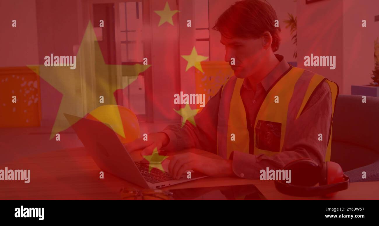Chinese flag image over construction worker using tablet and laptop in office Stock Photo
