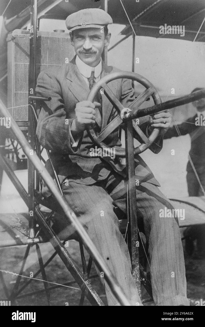 Glenn Curtiss at pilot's wheel of his biplane, Glass negatives, 1 negative: glass; 5 x 7 in. or smaller. Stock Photo