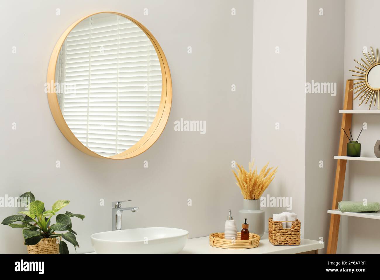 Round mirror over sink in bathroom. Interior design Stock Photo - Alamy